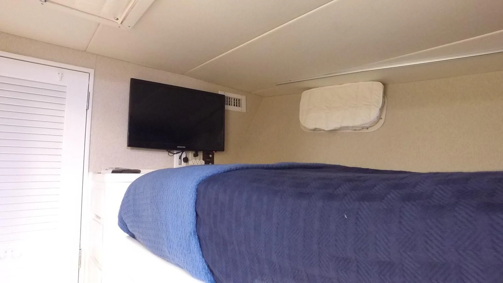 a bed with a television on it aboard BAREFOOT V Yacht for Sale