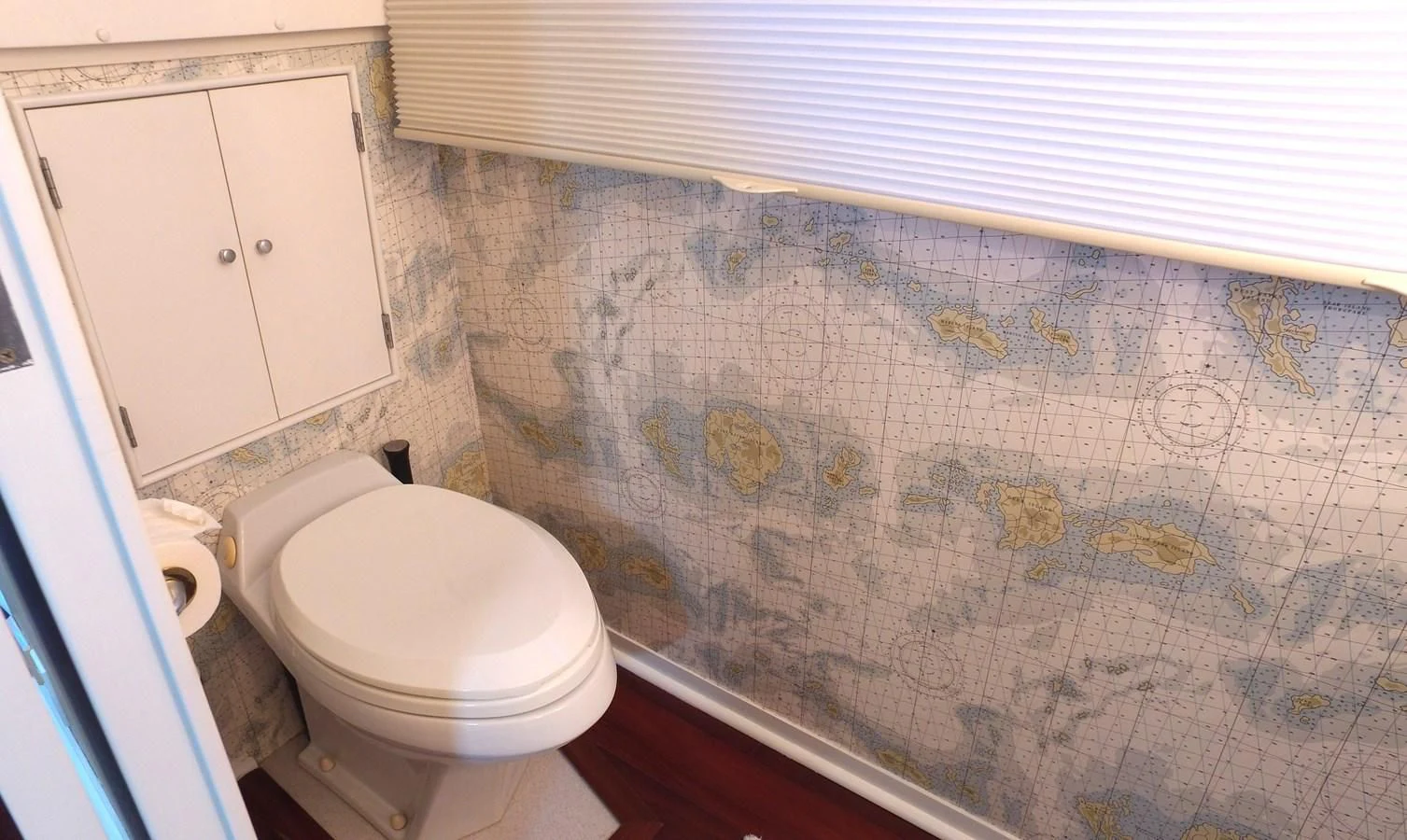 a bathroom with a toilet and a cabinet aboard BAREFOOT V Yacht for Sale