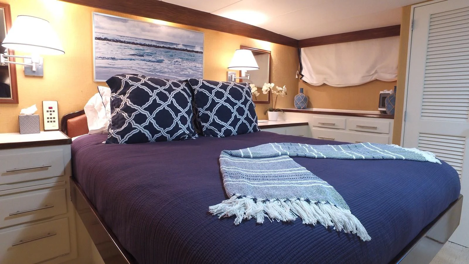 a bed with blue sheets aboard BAREFOOT V Yacht for Sale