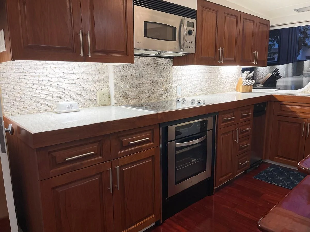 a kitchen with wooden cabinets aboard BAREFOOT V Yacht for Sale
