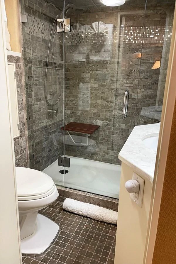 a bathroom with a glass shower aboard BAREFOOT V Yacht for Sale