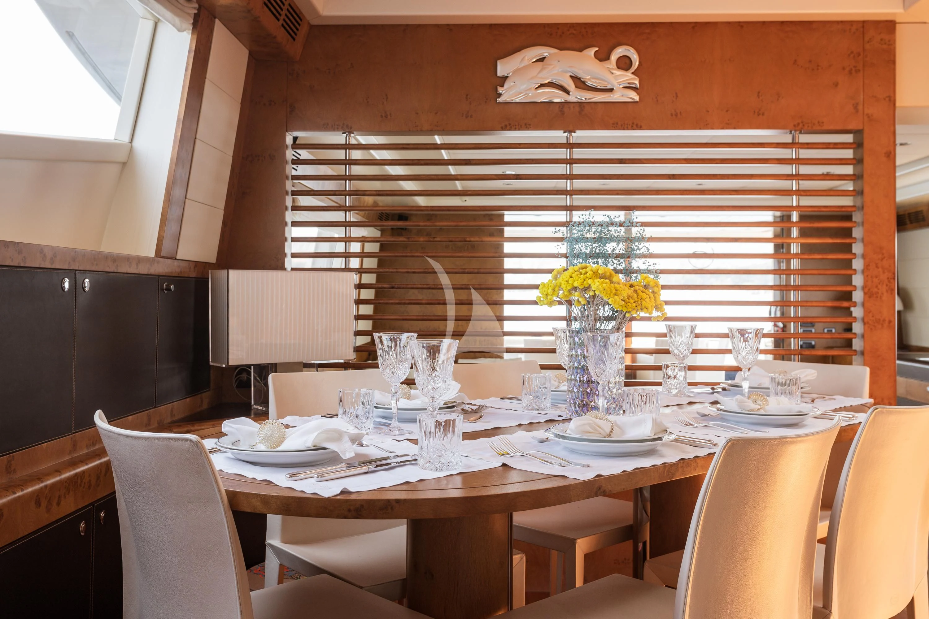 a dining table with plates and glasses aboard ANLIA Yacht for Sale