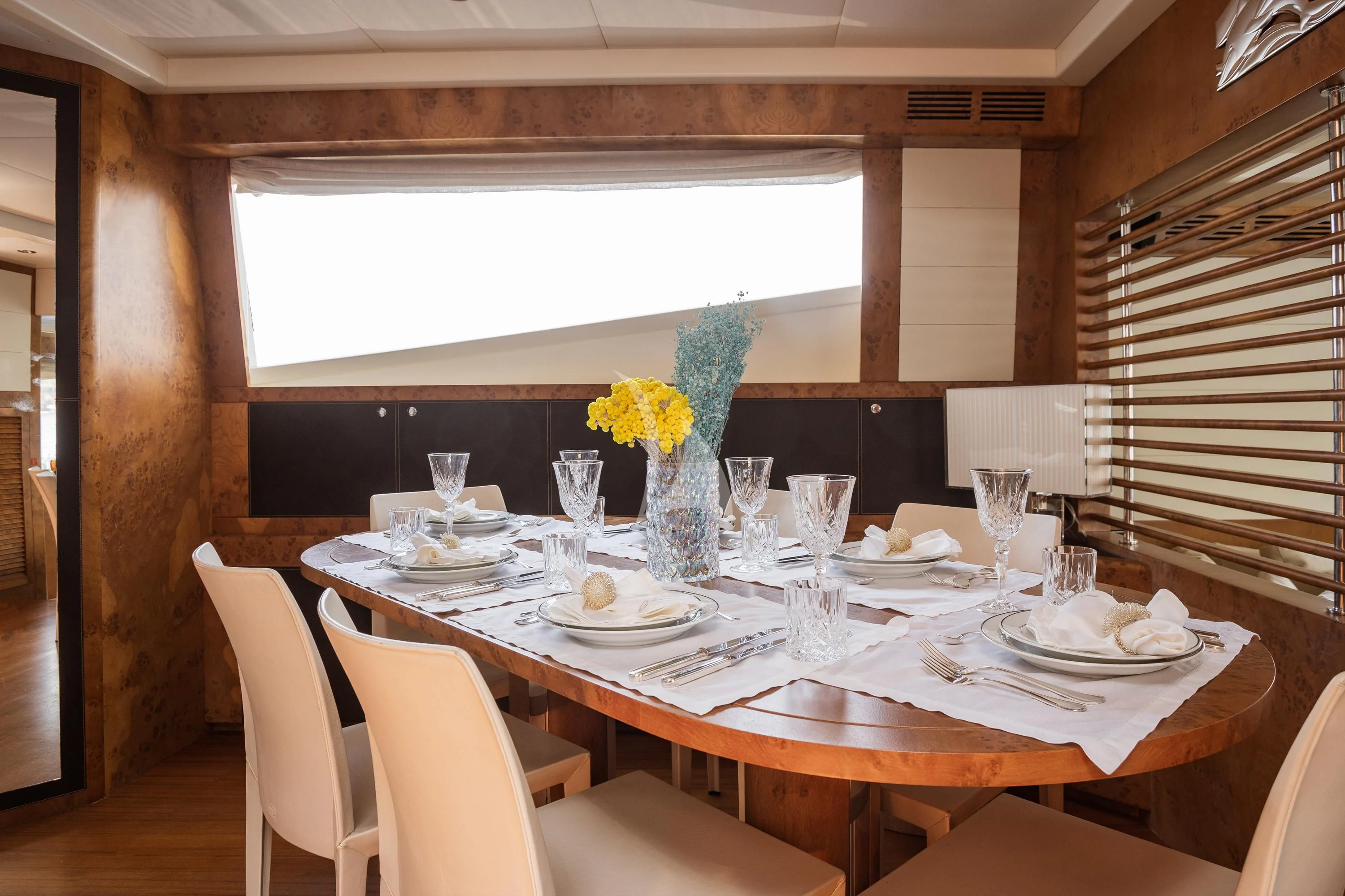 a table with plates and glasses aboard ANLIA Yacht for Sale