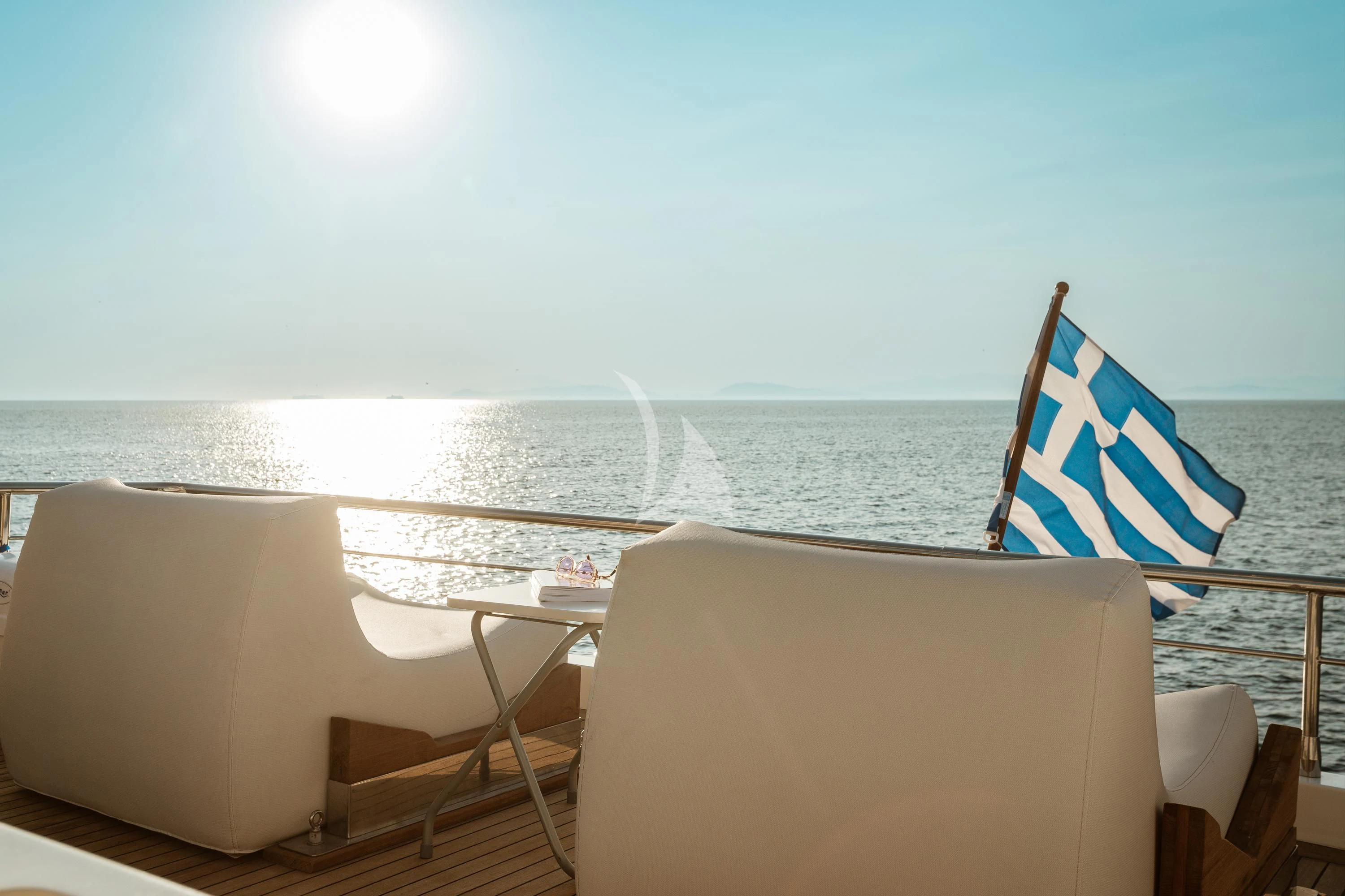 a chair and a table on a boat aboard ANLIA Yacht for Sale