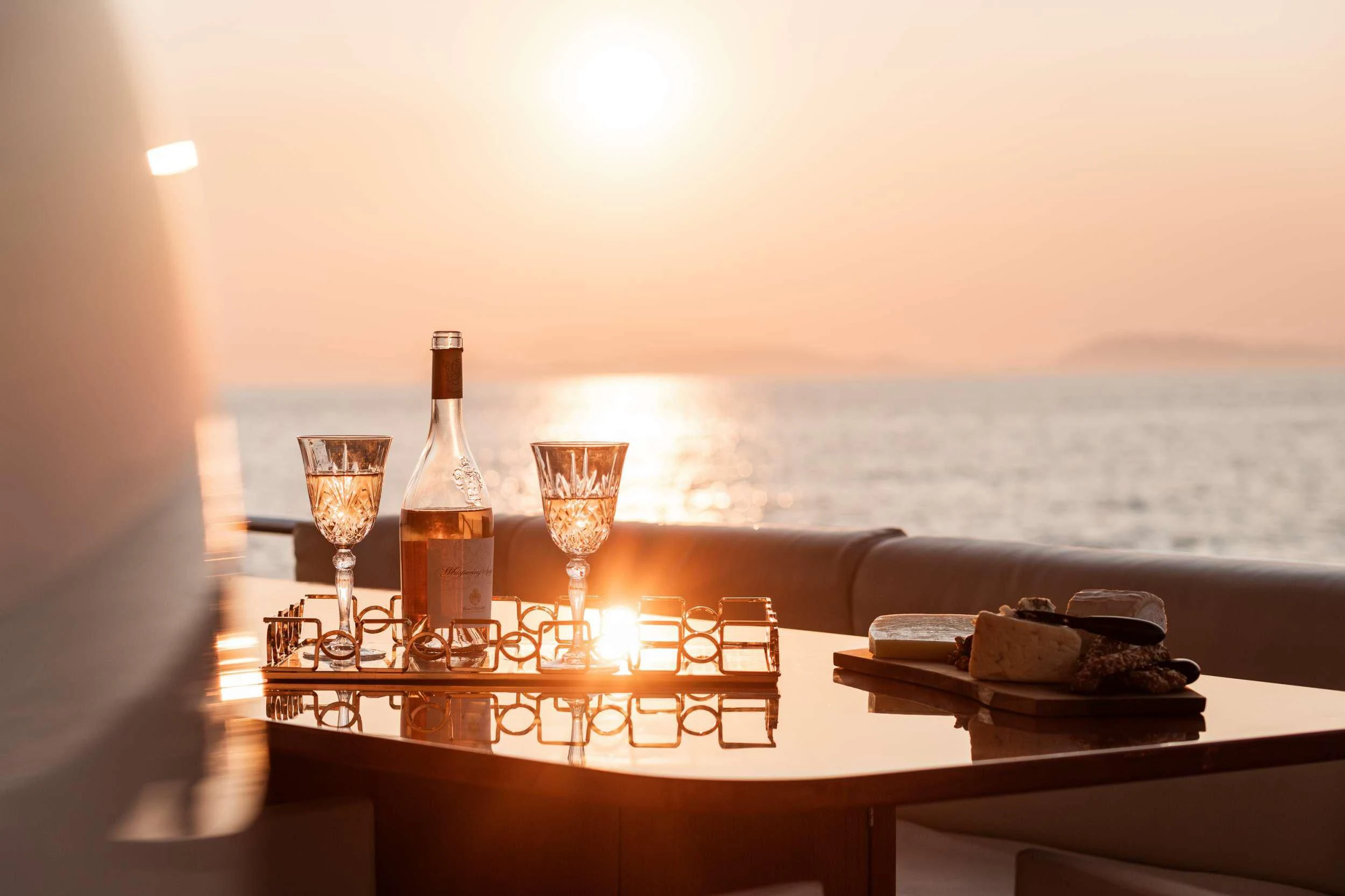 a table with wine glasses and bottles aboard ANLIA Yacht for Sale