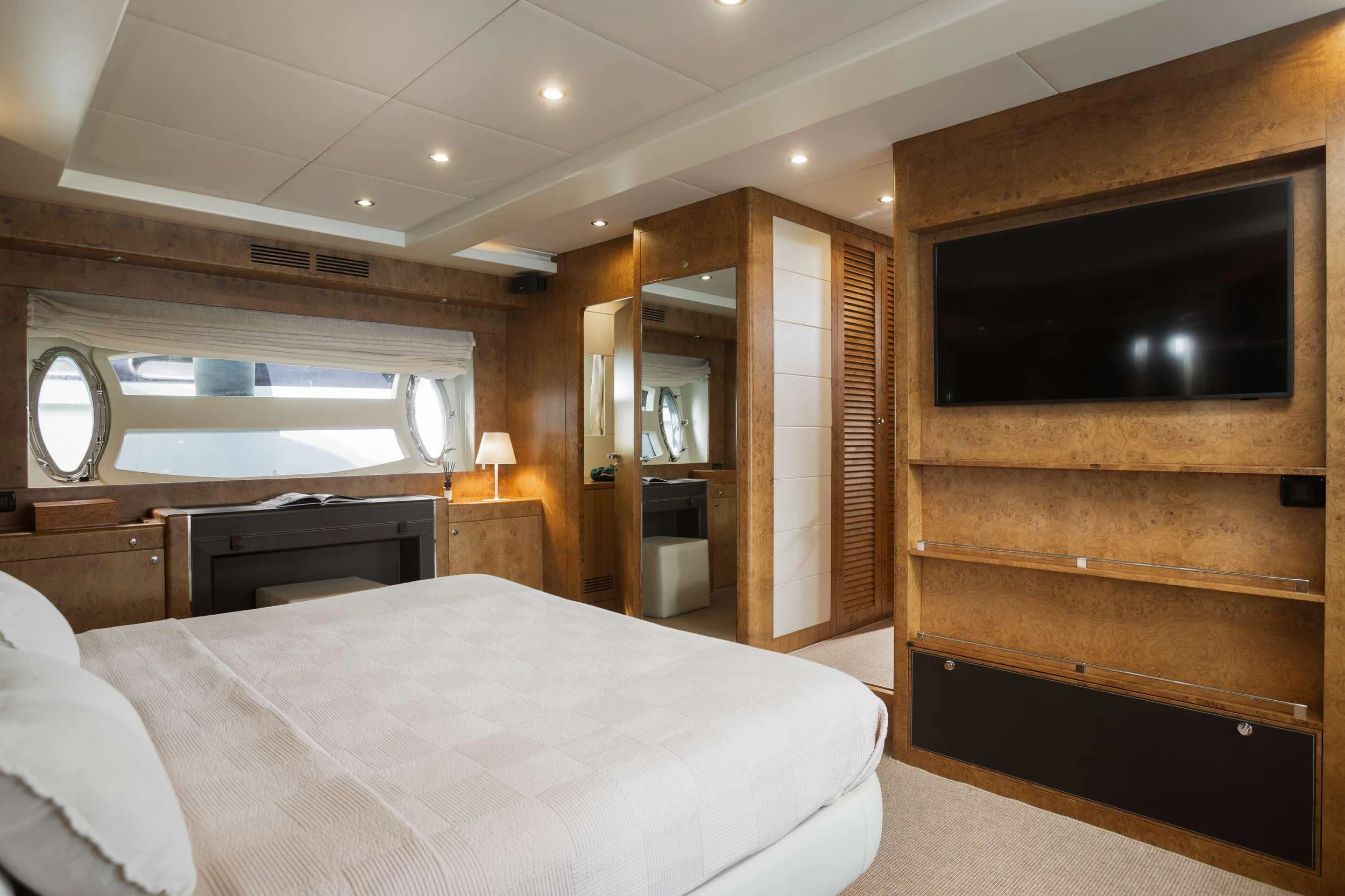 a bedroom with a bed and a television aboard ANLIA Yacht for Sale