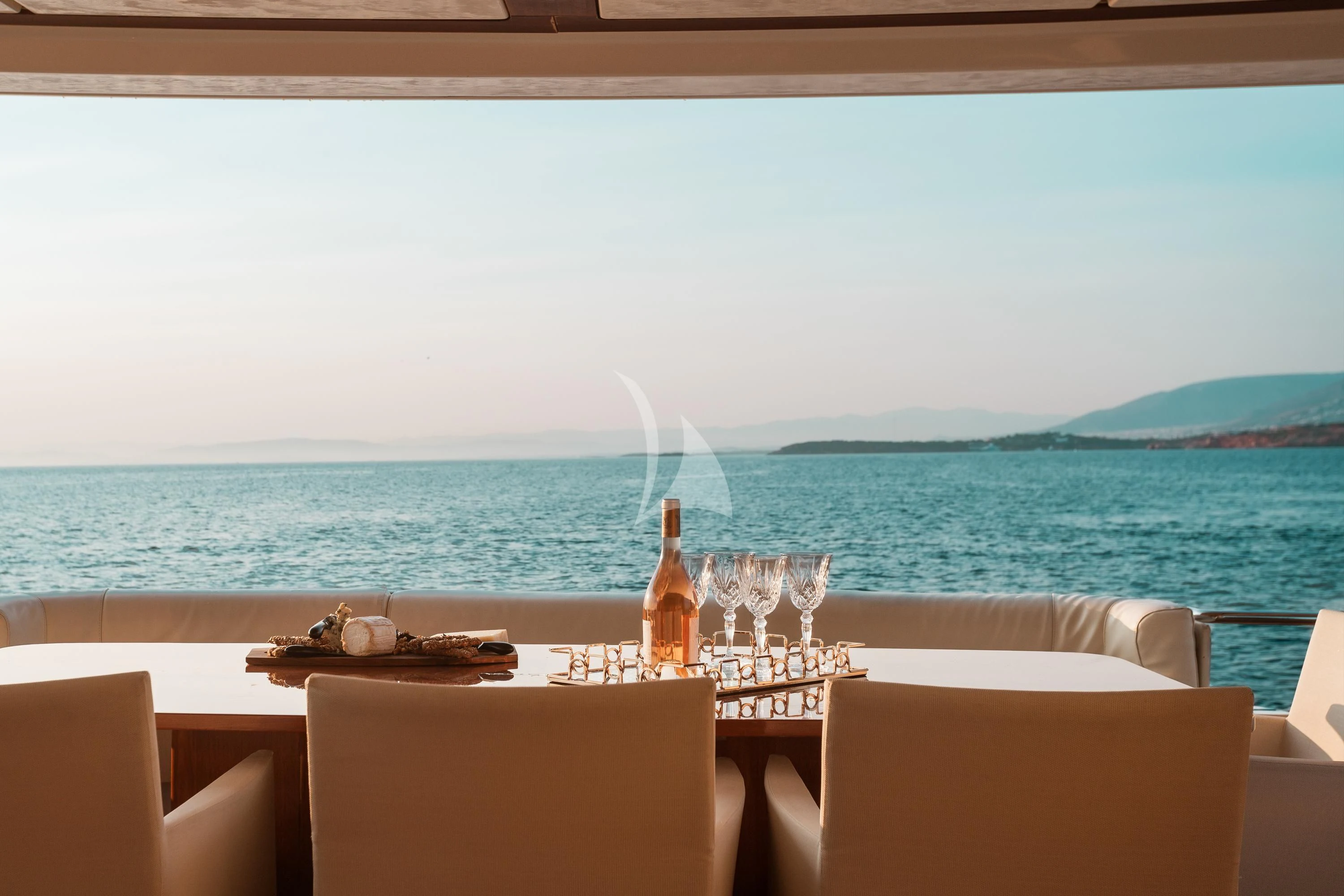 a table with wine glasses on it aboard ANLIA Yacht for Sale