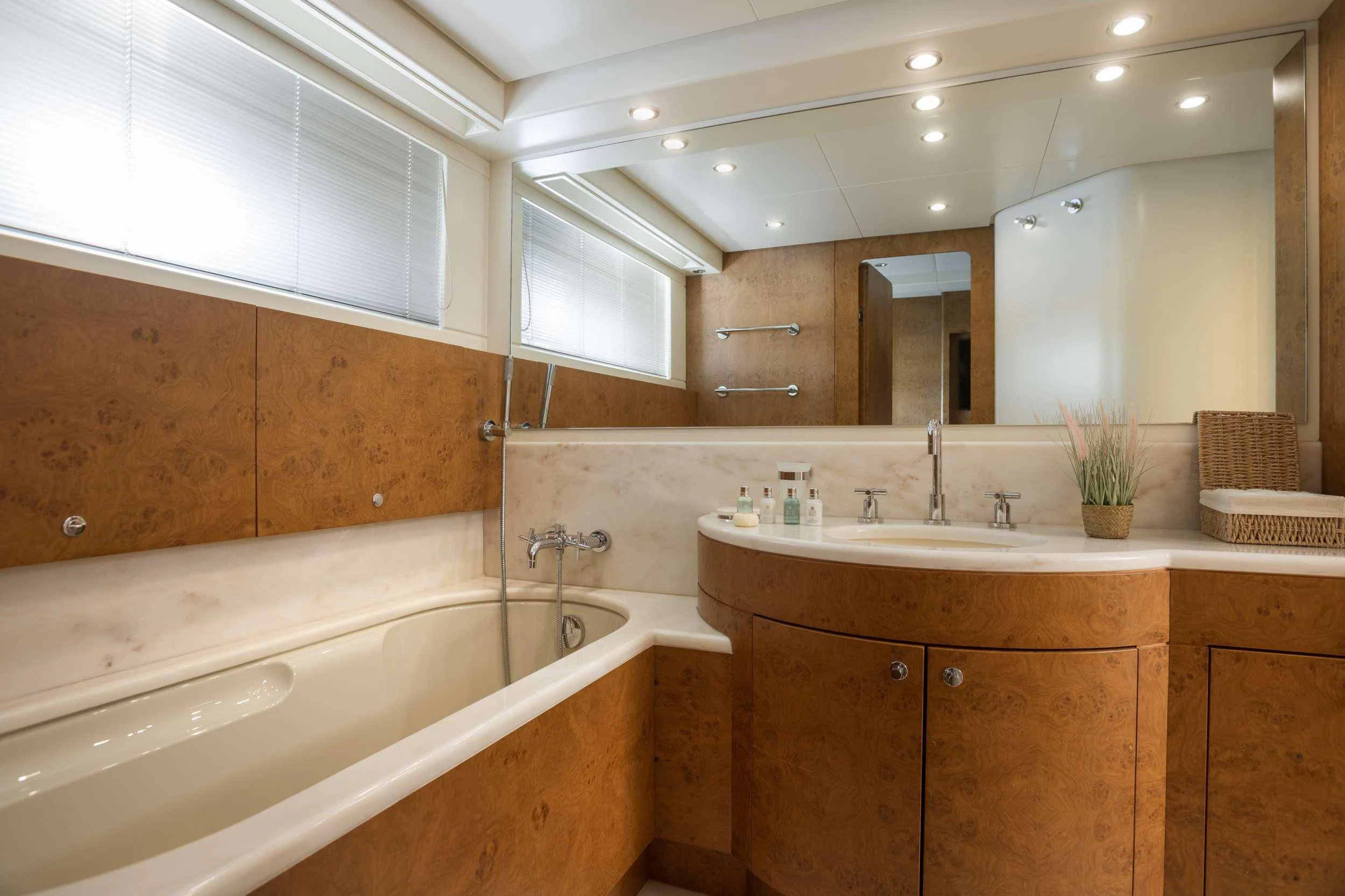 a bathroom with a bathtub and sinks aboard ANLIA Yacht for Sale