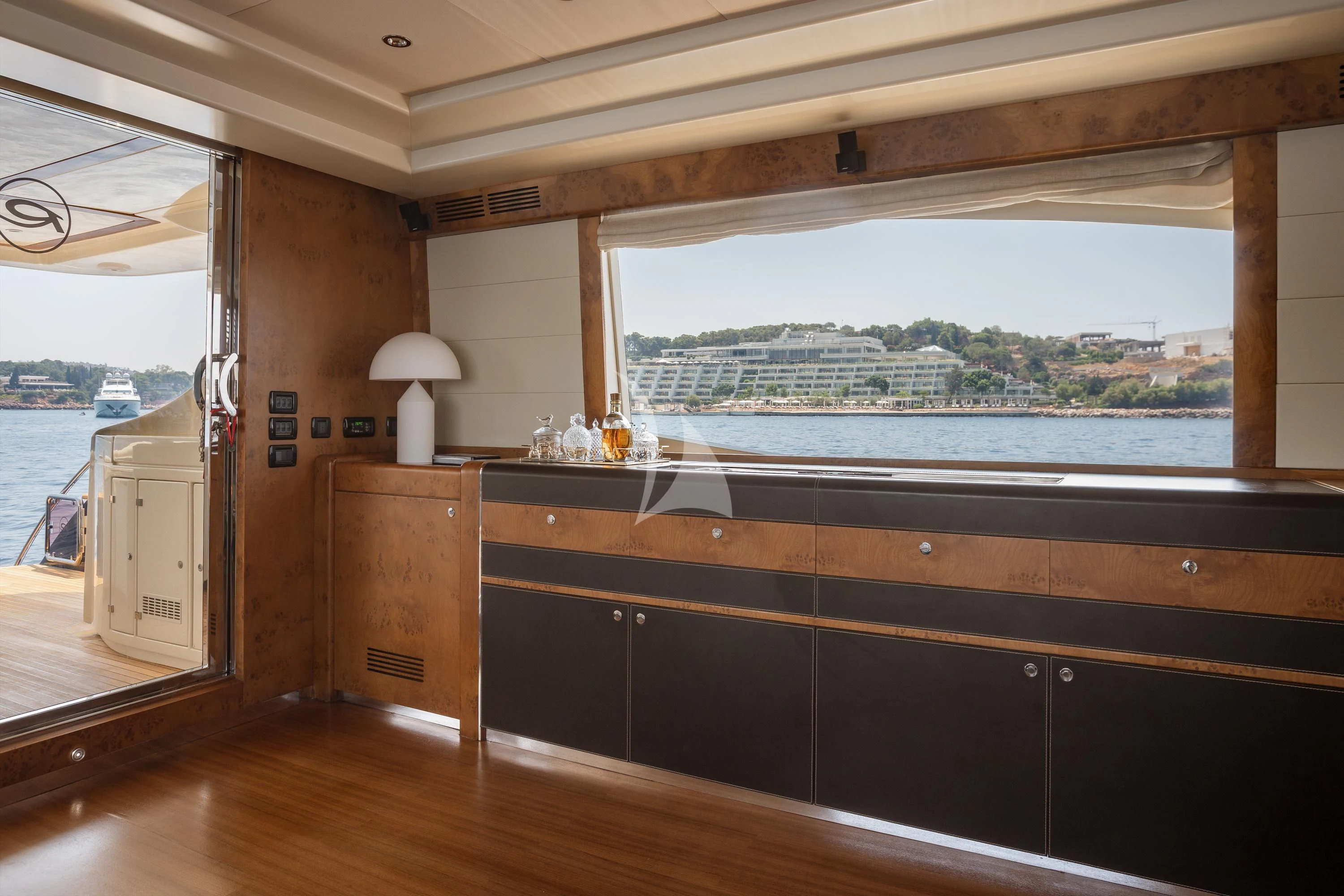 a room with a large window and a wood floor aboard ANLIA Yacht for Sale
