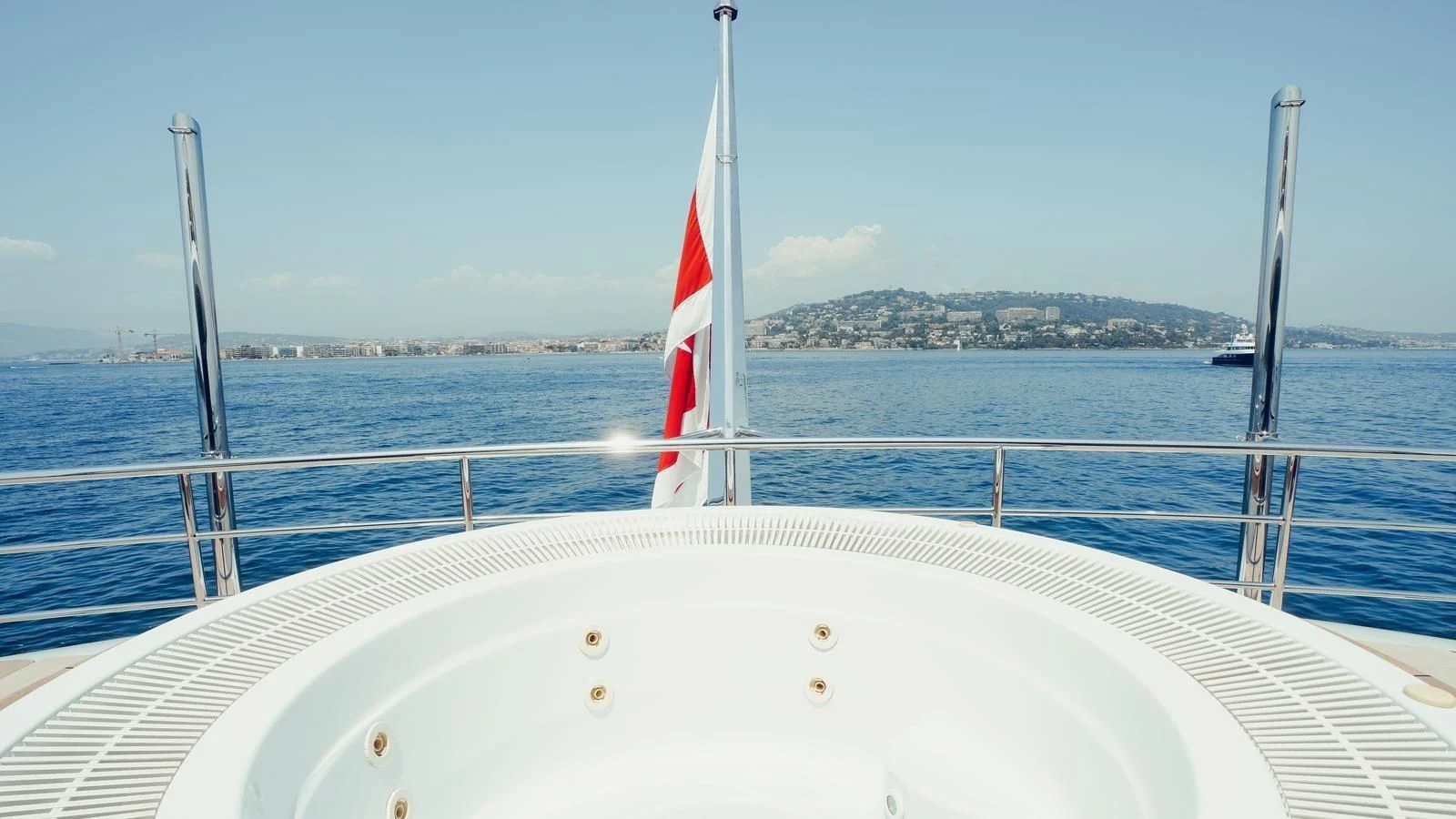 a boat with a flag on the front aboard TATIANA I Yacht for Sale