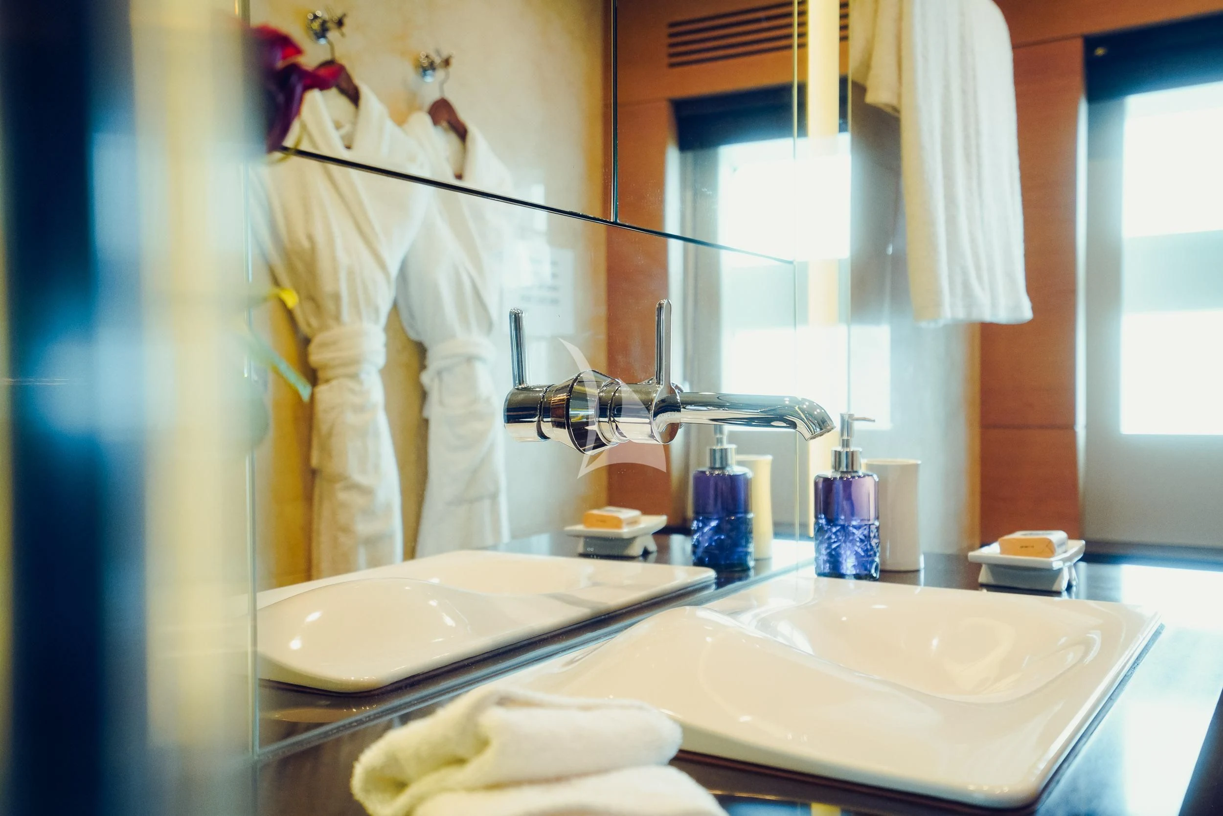 a bathroom with a sink and towels aboard TATIANA I Yacht for Sale