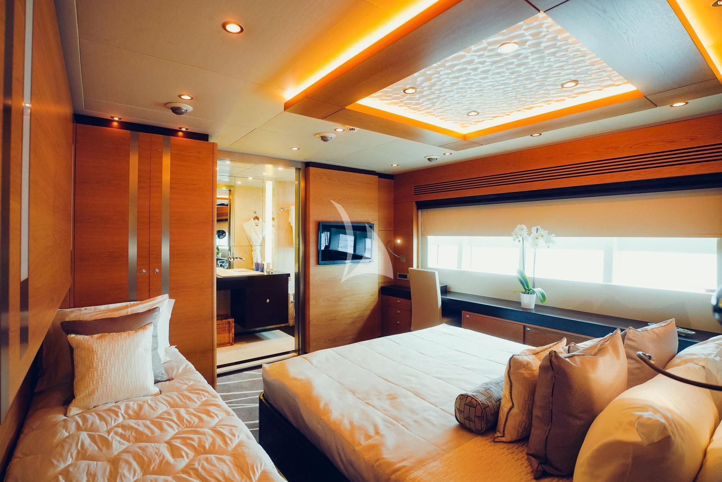 a room with a bed and a television aboard TATIANA I Yacht for Sale