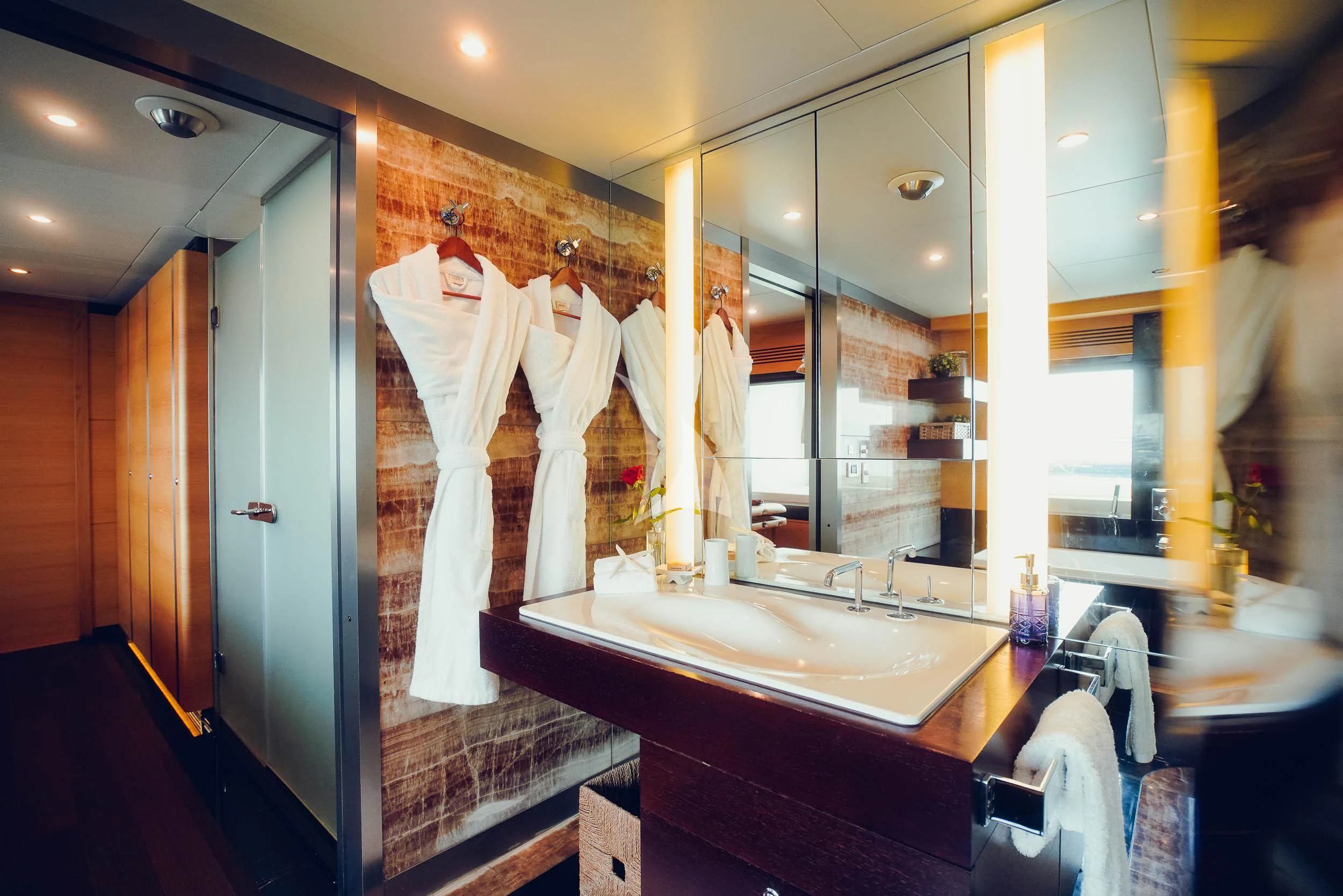 a bathroom with a large mirror aboard TATIANA I Yacht for Sale