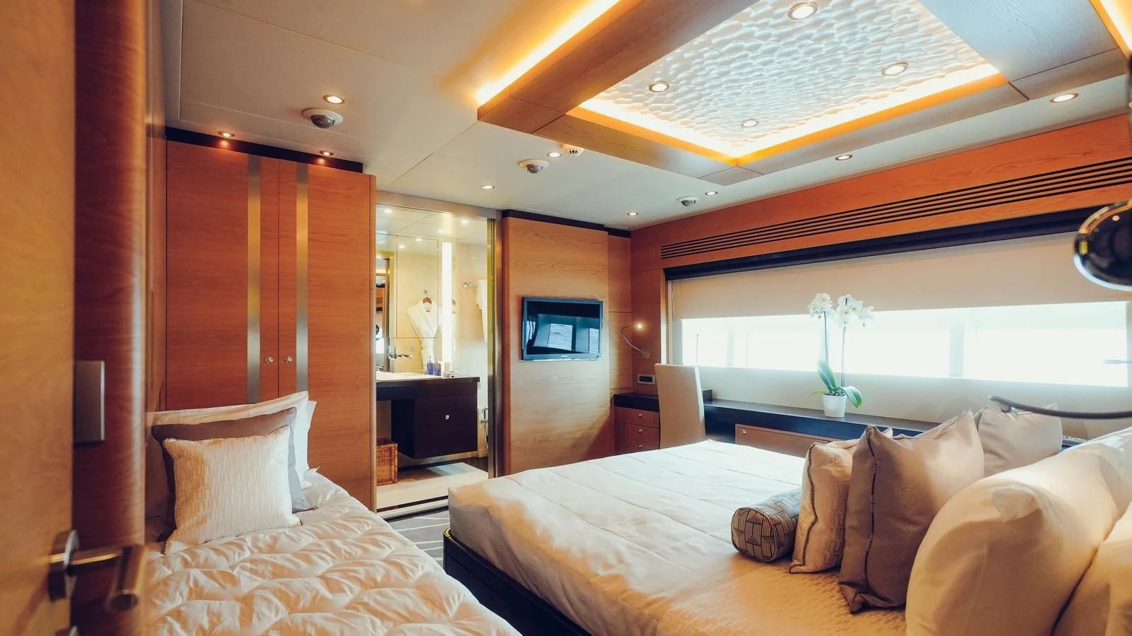a room with a bed and a television aboard TATIANA I Yacht for Sale