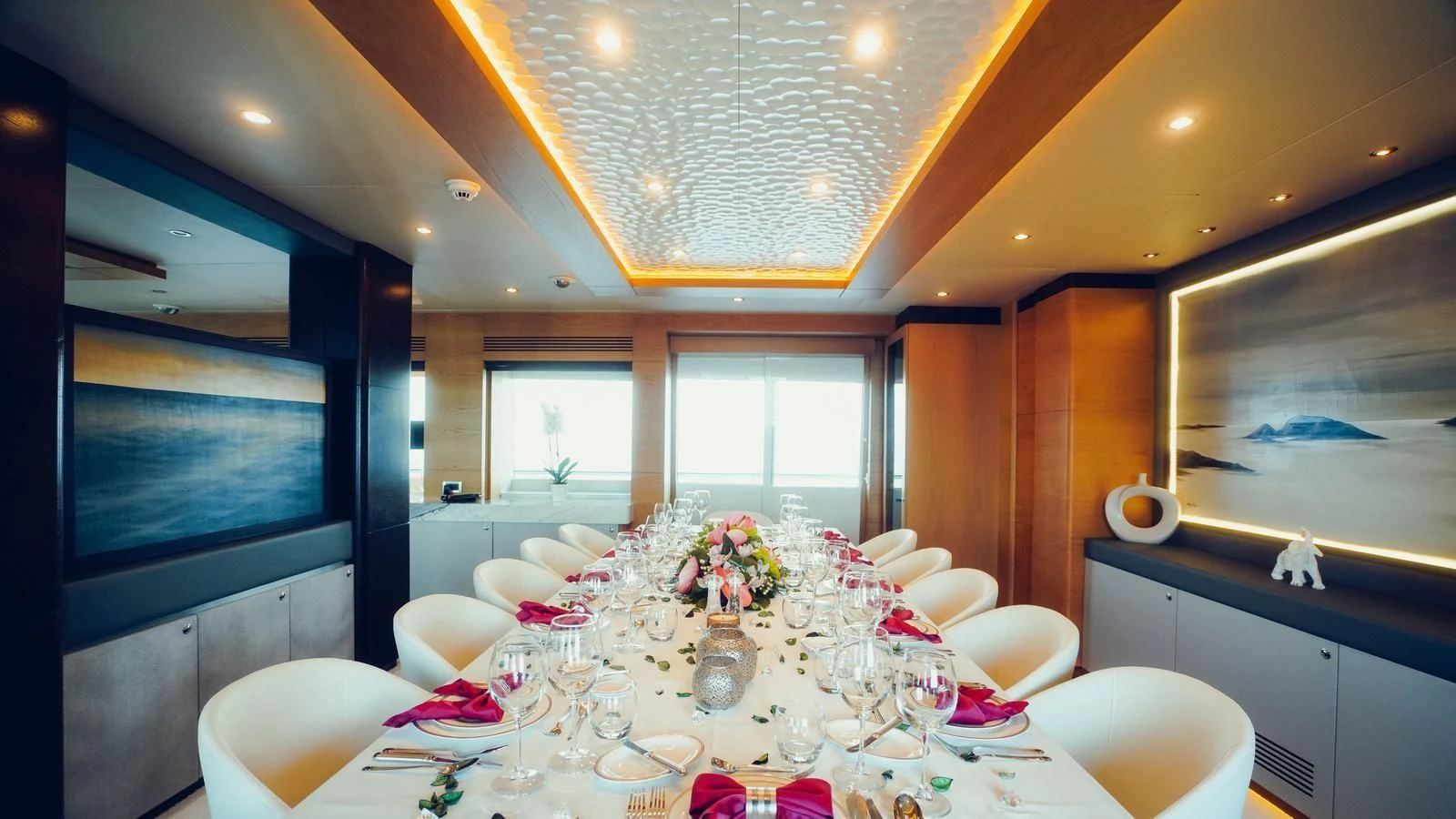 a dining room with a table set aboard TATIANA I Yacht for Sale
