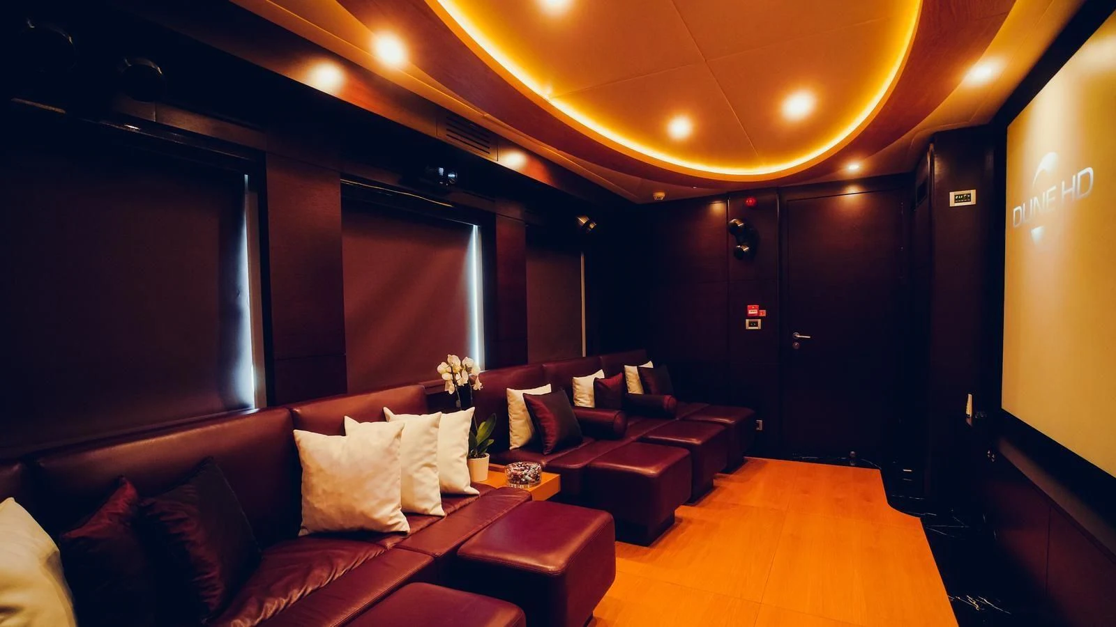 a living room with a couch and a wood floor aboard TATIANA I Yacht for Sale