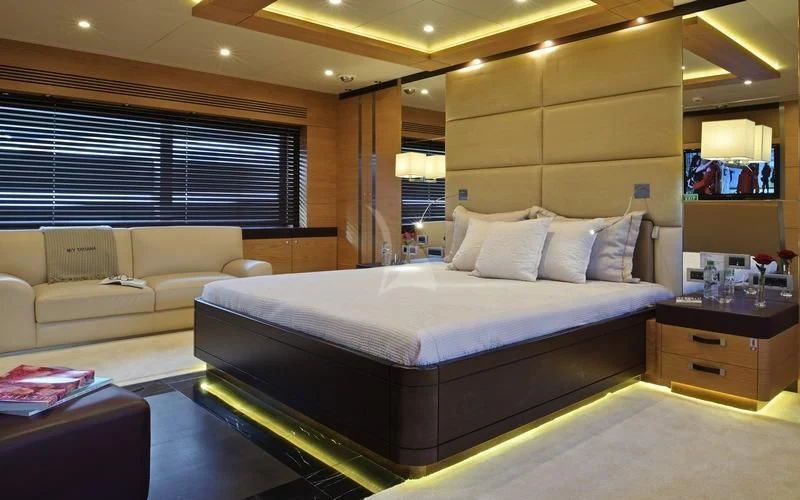 a room with a bed and a television aboard TATIANA I Yacht for Sale