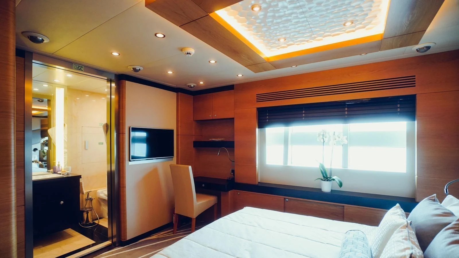 a bedroom with a bed and a tv aboard TATIANA I Yacht for Sale