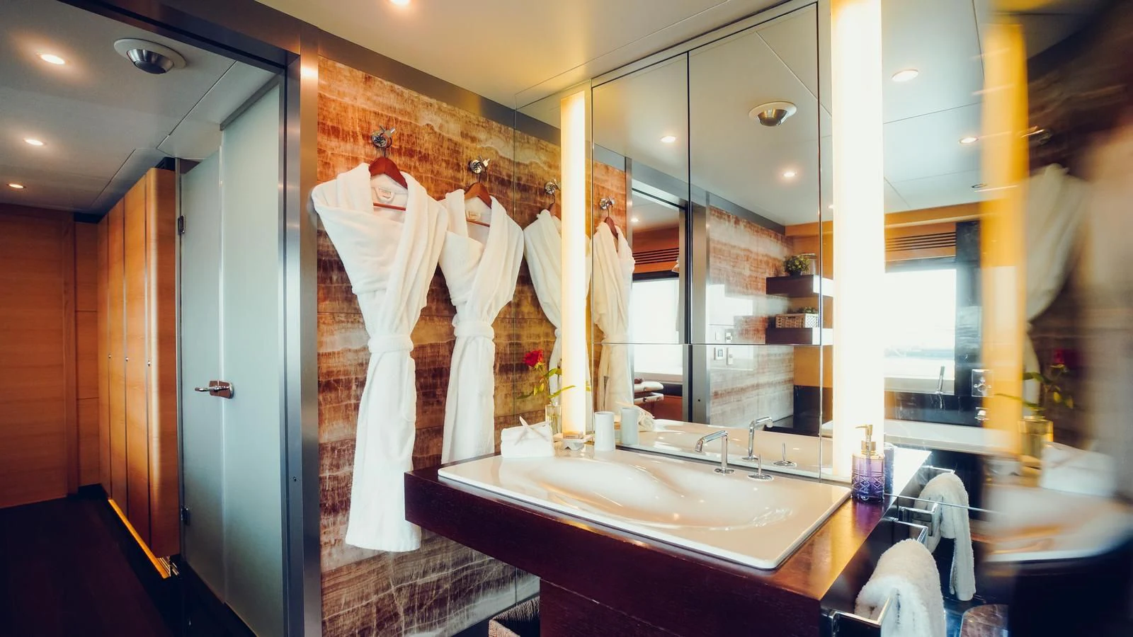 a bathroom with a large mirror aboard TATIANA I Yacht for Sale