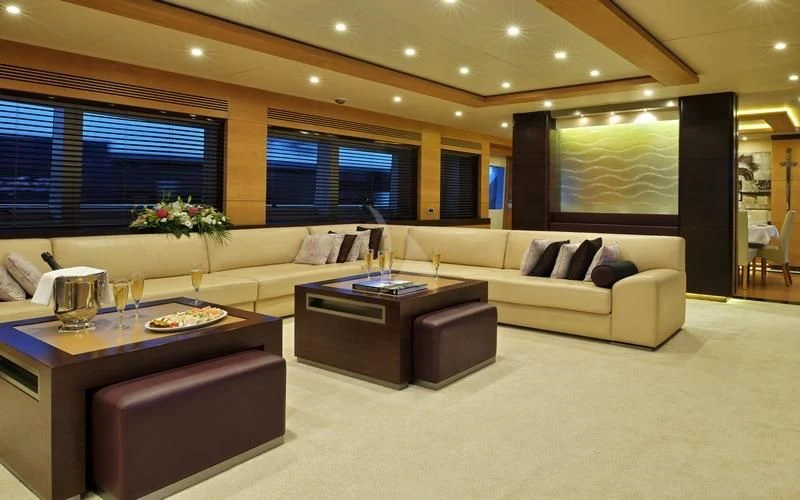 a living room with a couch and a coffee table aboard TATIANA I Yacht for Sale