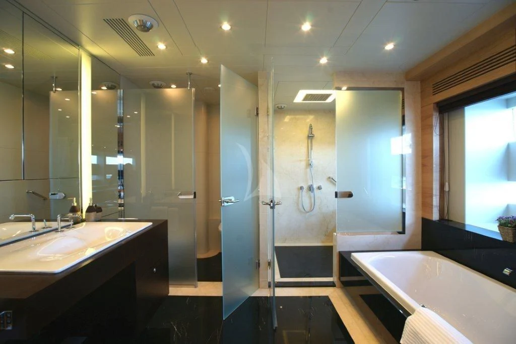 a bathroom with a large mirror aboard TATIANA I Yacht for Sale