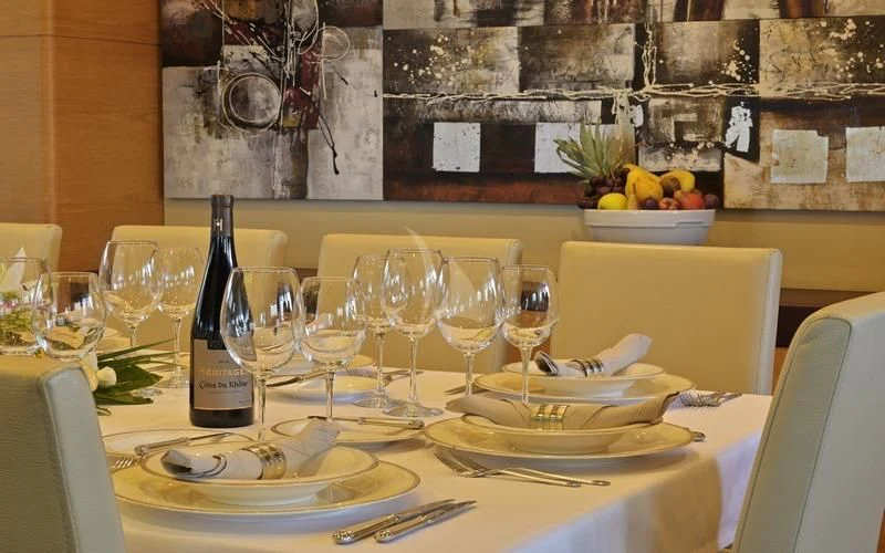 a table with wine glasses and plates aboard TATIANA I Yacht for Sale