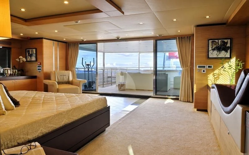 a large bedroom with a balcony aboard TATIANA I Yacht for Sale