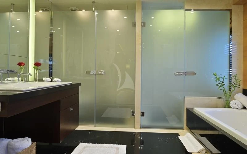 a bathroom with a glass shower aboard TATIANA I Yacht for Sale
