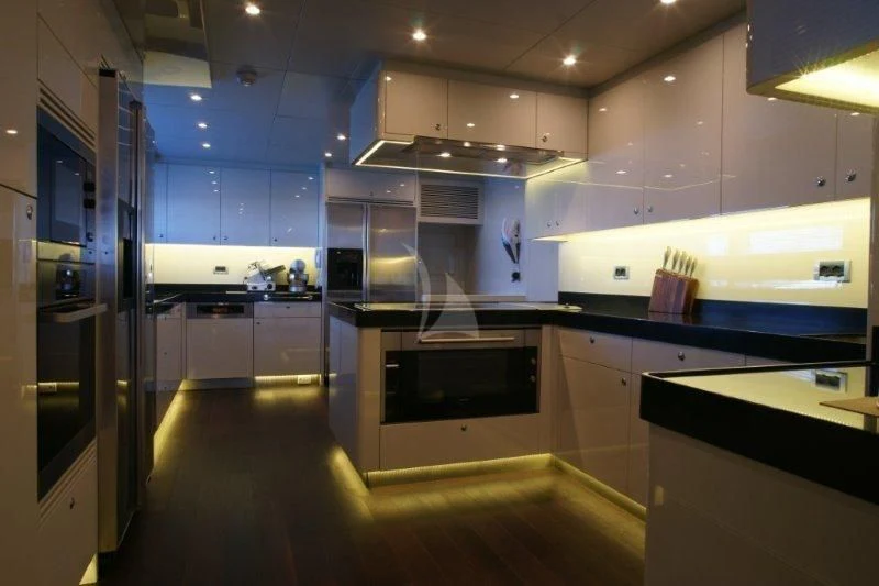 a kitchen with a stove and cabinets aboard TATIANA I Yacht for Sale