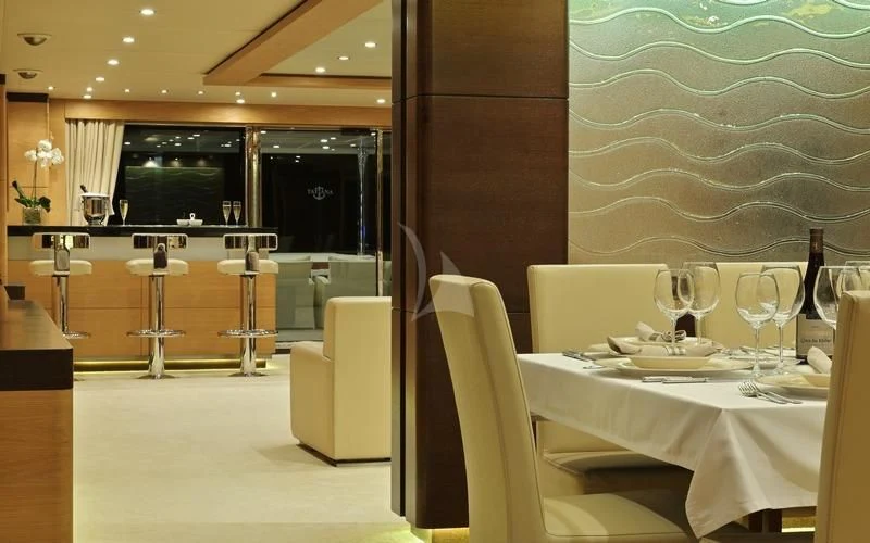 a room with tables and chairs aboard TATIANA I Yacht for Sale