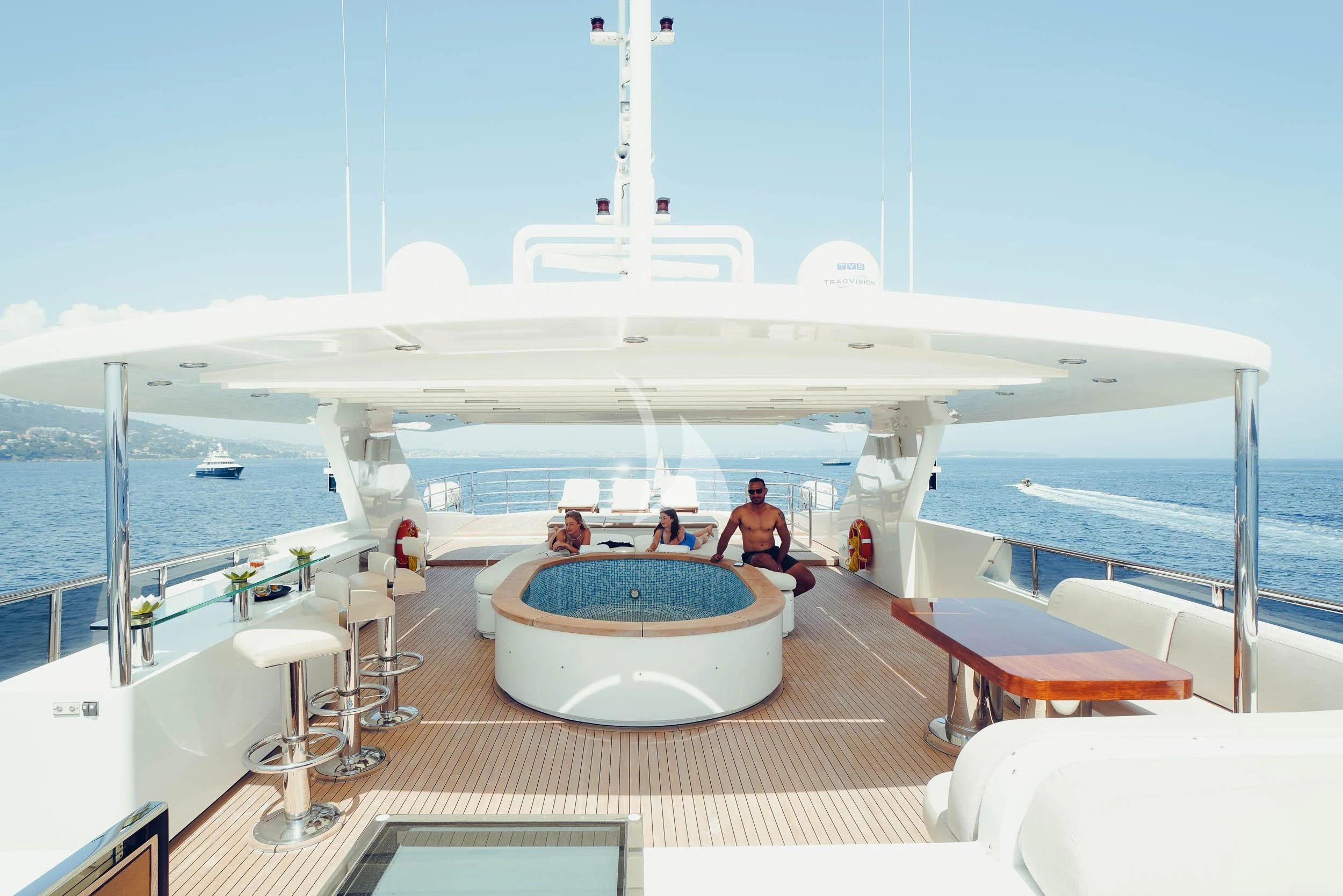 a large white airplane with people sitting on the deck aboard TATIANA I Yacht for Sale