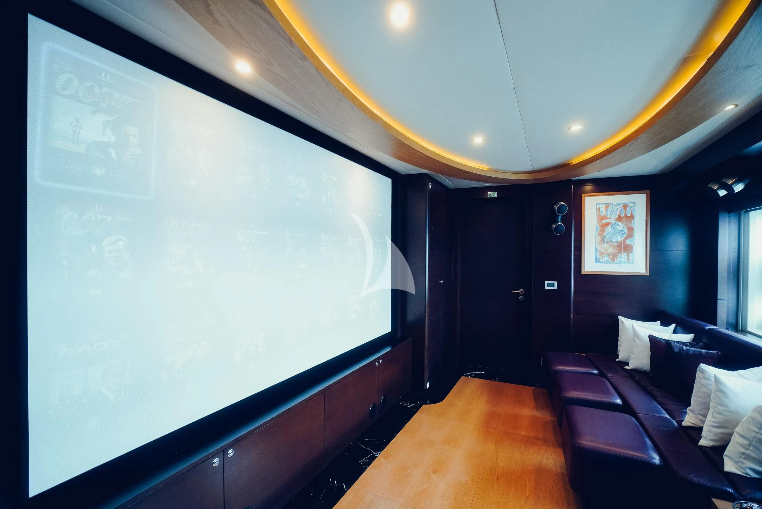 a room with a couch and a tv on the wall aboard TATIANA I Yacht for Sale