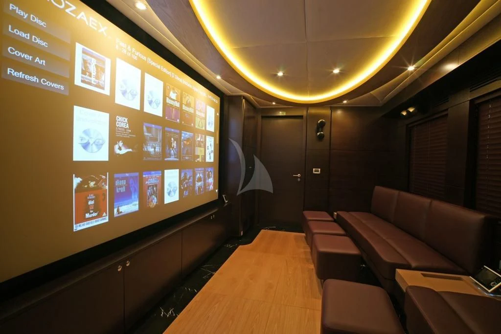 a room with a couch and a television aboard TATIANA I Yacht for Sale