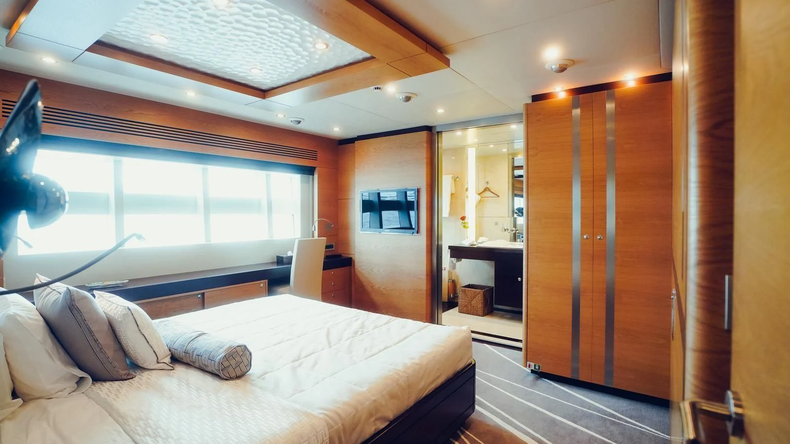 a room with a bed and a wood door aboard TATIANA I Yacht for Sale