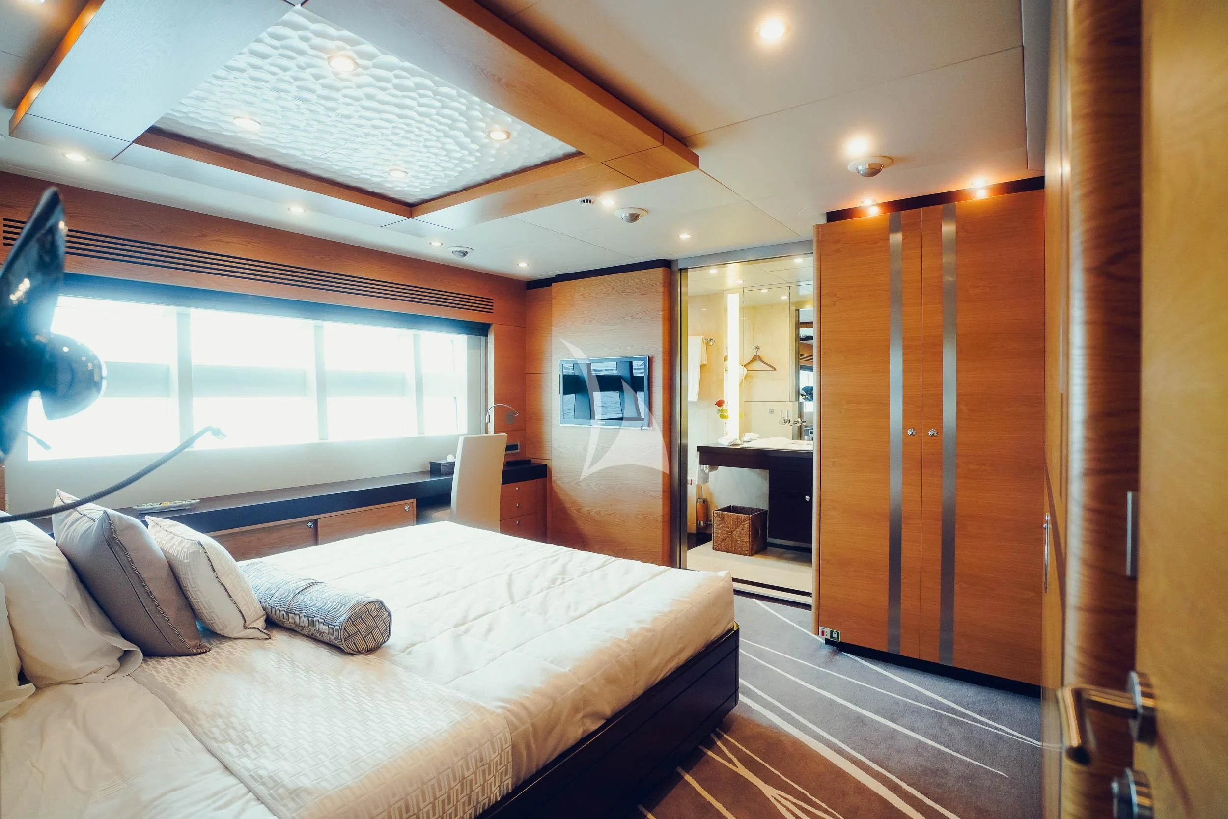 a bedroom with a bed and a large window aboard TATIANA I Yacht for Sale