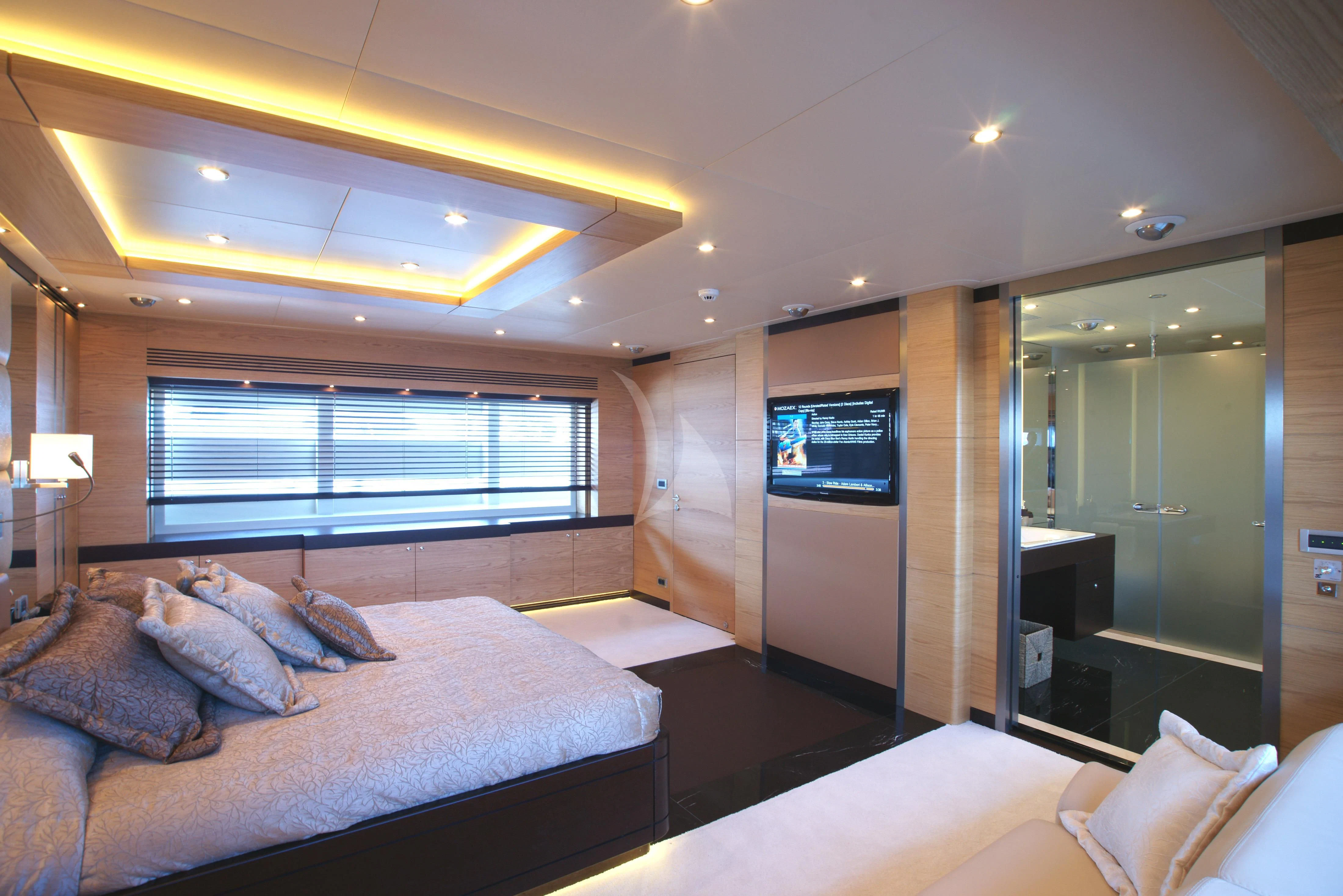 a bedroom with a bed and a tv aboard TATIANA I Yacht for Sale