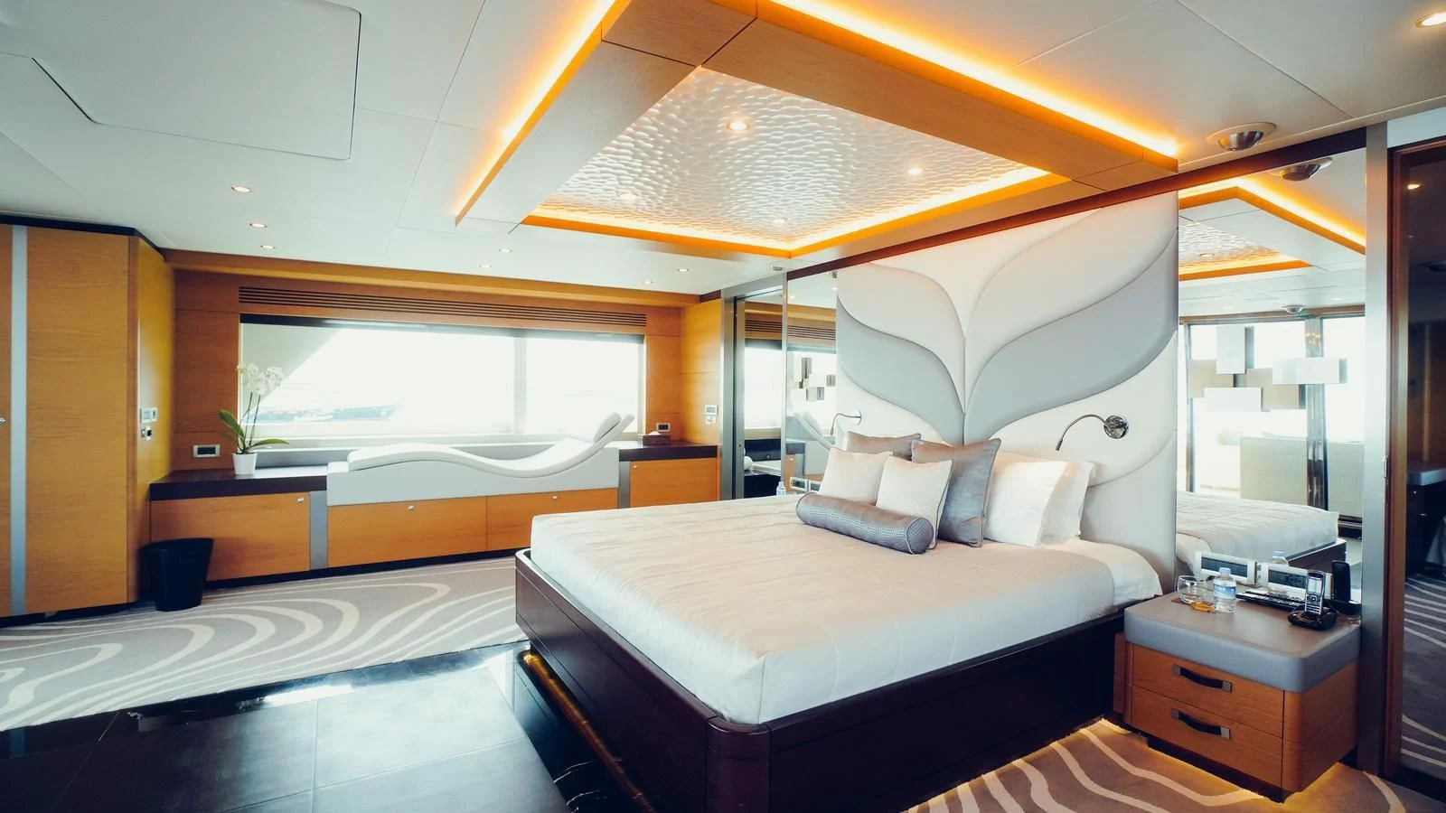 a room with a bed and a large window aboard TATIANA I Yacht for Sale