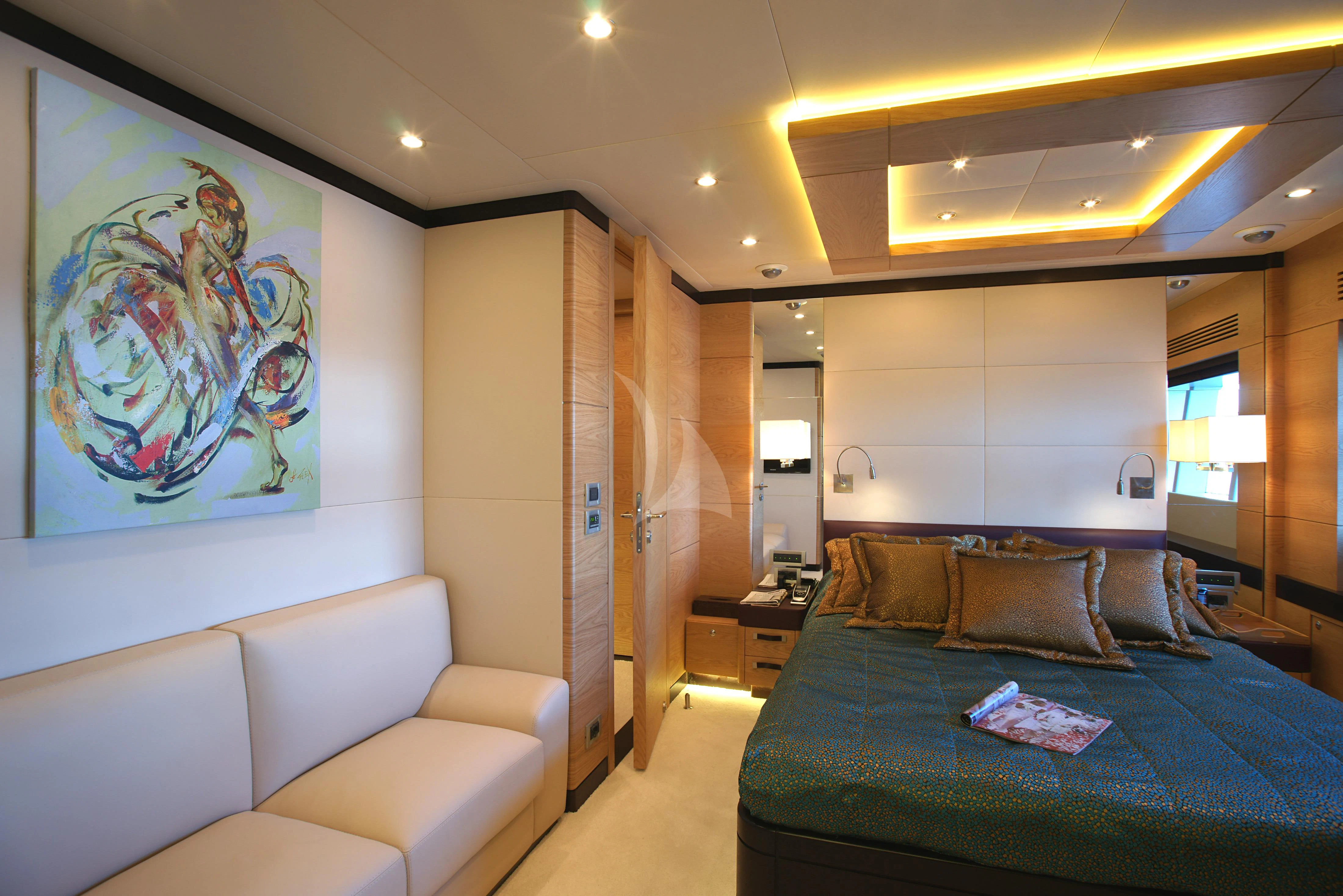 a large living room with a blue couch and a large painting aboard TATIANA I Yacht for Sale