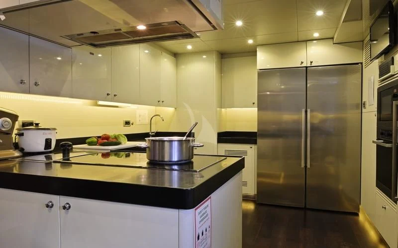 a kitchen with a stainless steel stove aboard TATIANA I Yacht for Sale