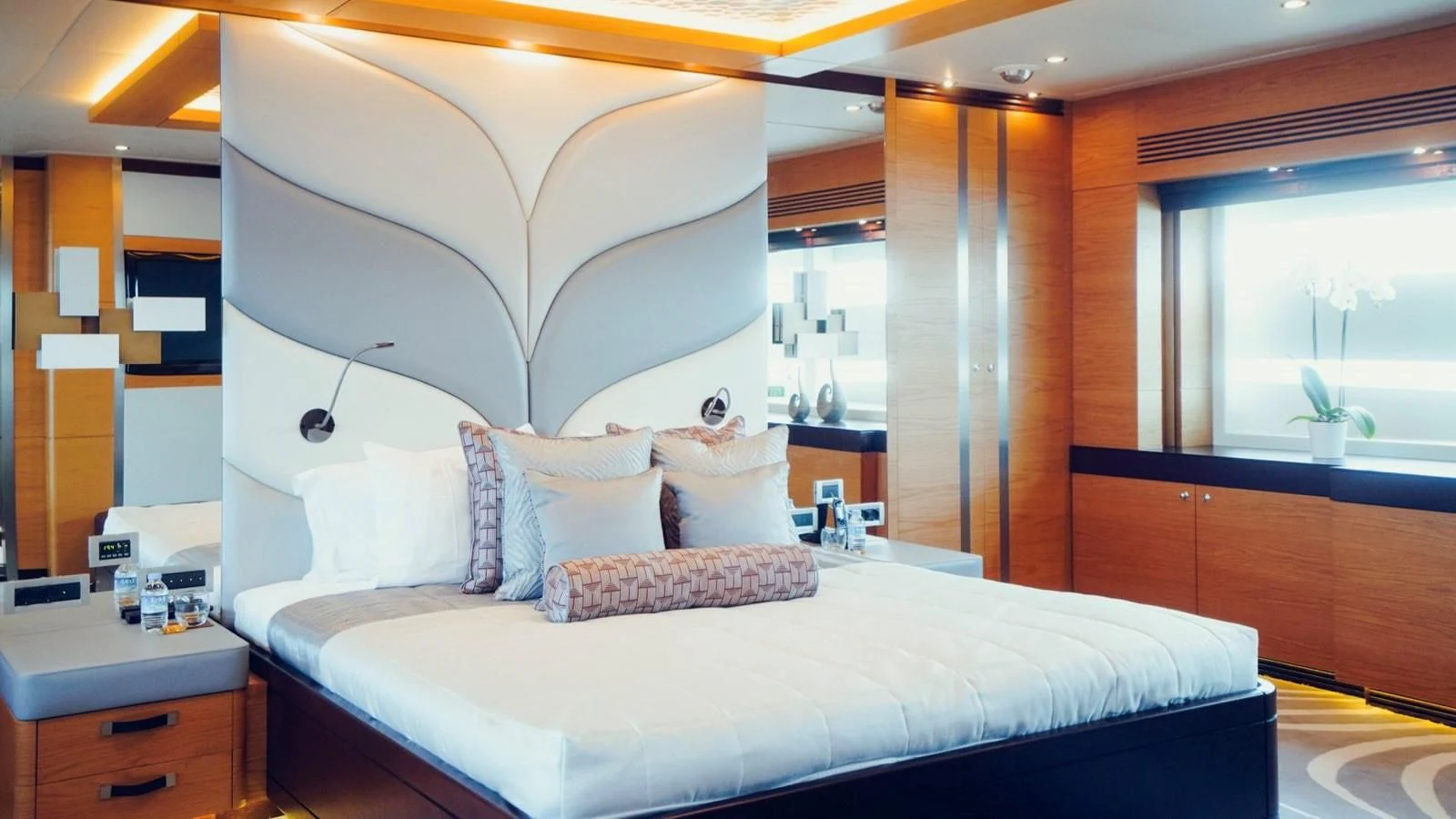 a bed with a white bed spread aboard TATIANA I Yacht for Sale