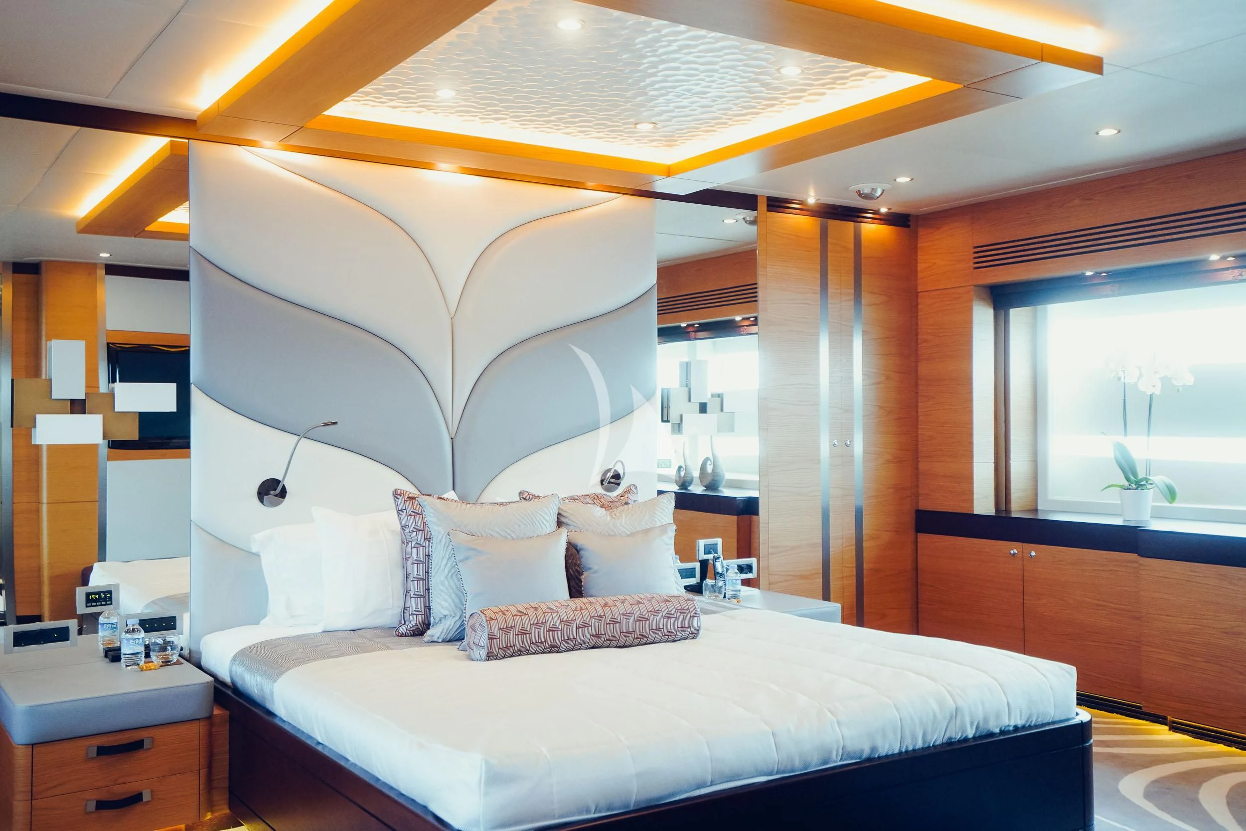 a bed with a white bed spread aboard TATIANA I Yacht for Sale