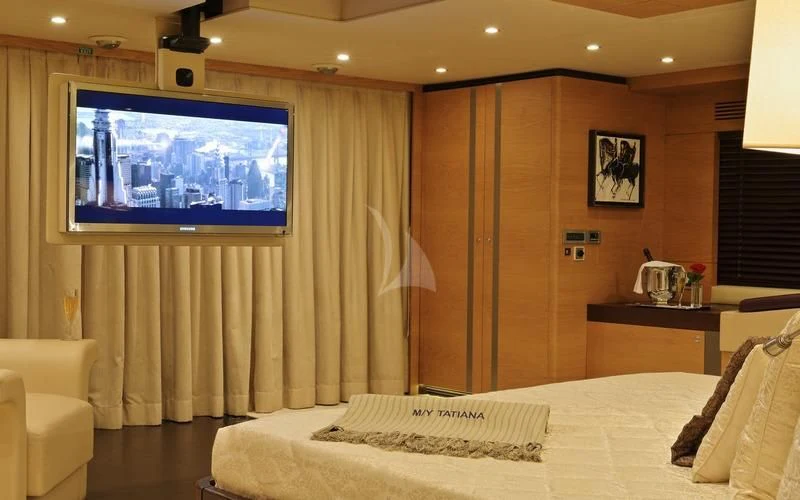 a room with a bed and a tv aboard TATIANA I Yacht for Sale