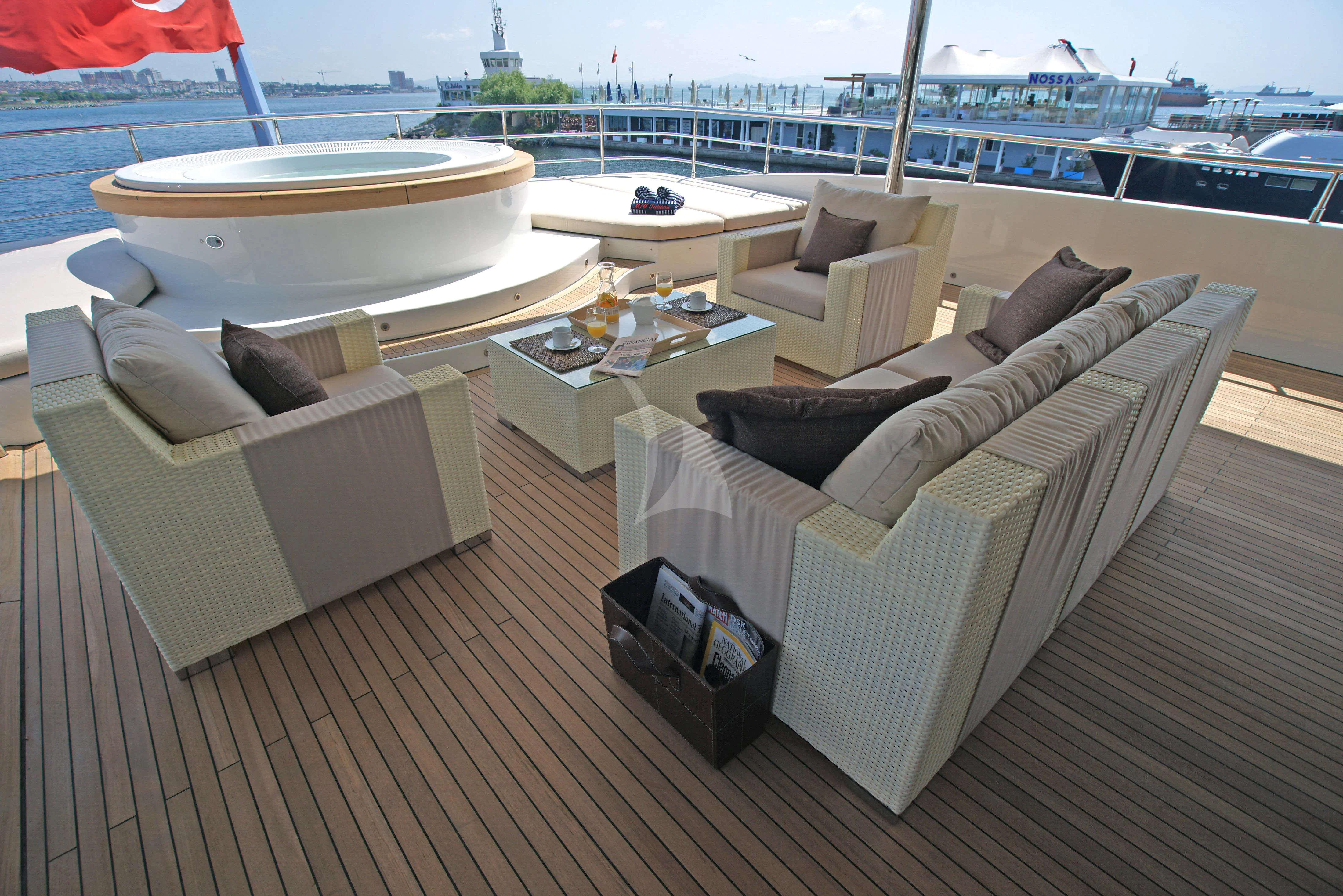 a deck with couches and a table on it aboard TATIANA I Yacht for Sale