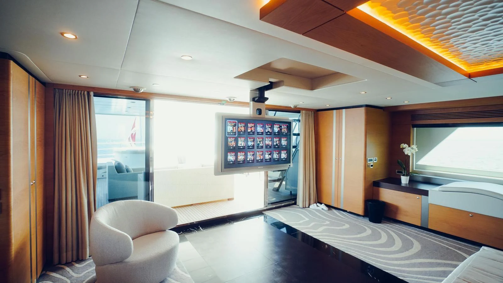 a room with a tv and a table aboard TATIANA I Yacht for Sale
