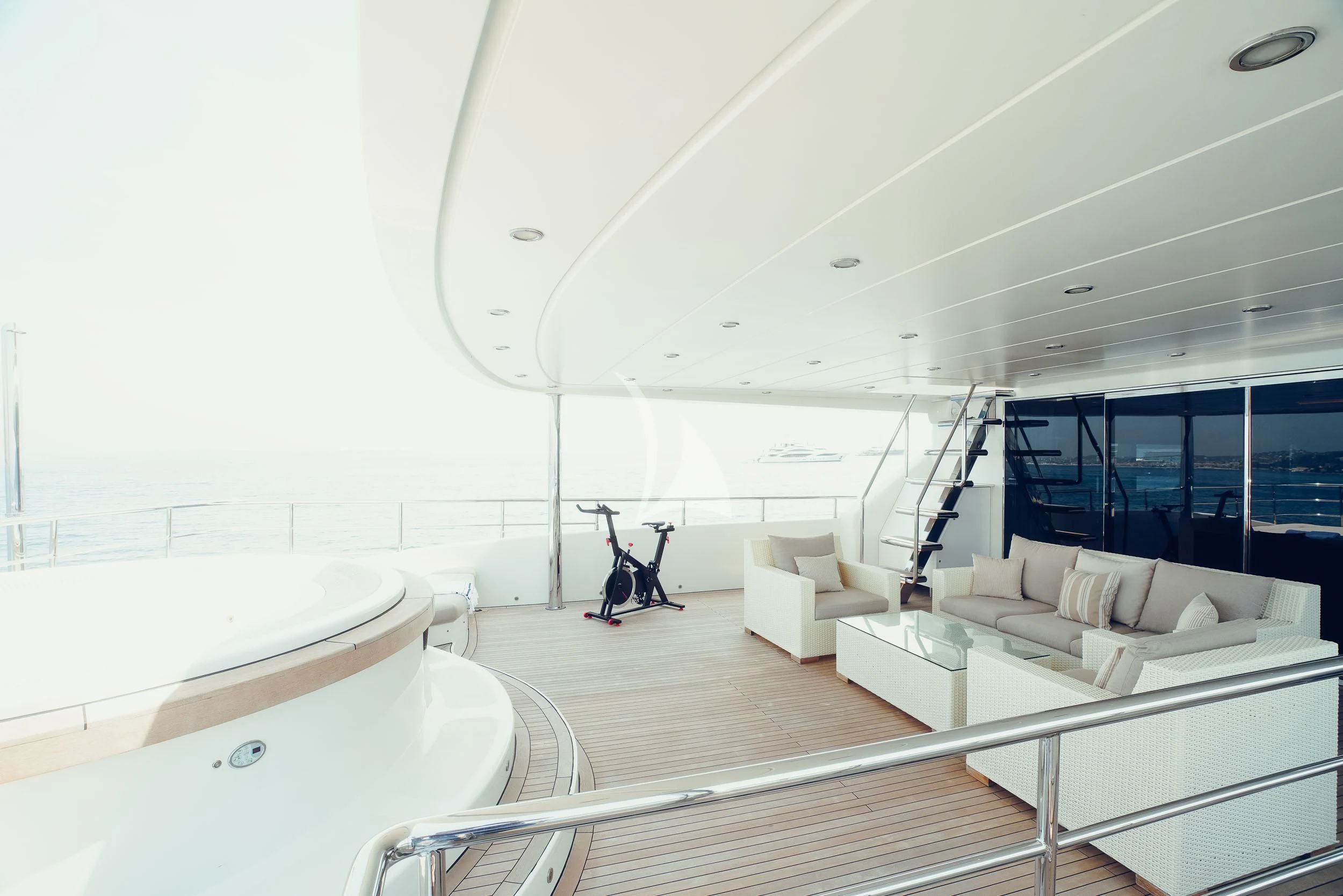 a room with a white couch and a white table and chairs aboard TATIANA I Yacht for Sale