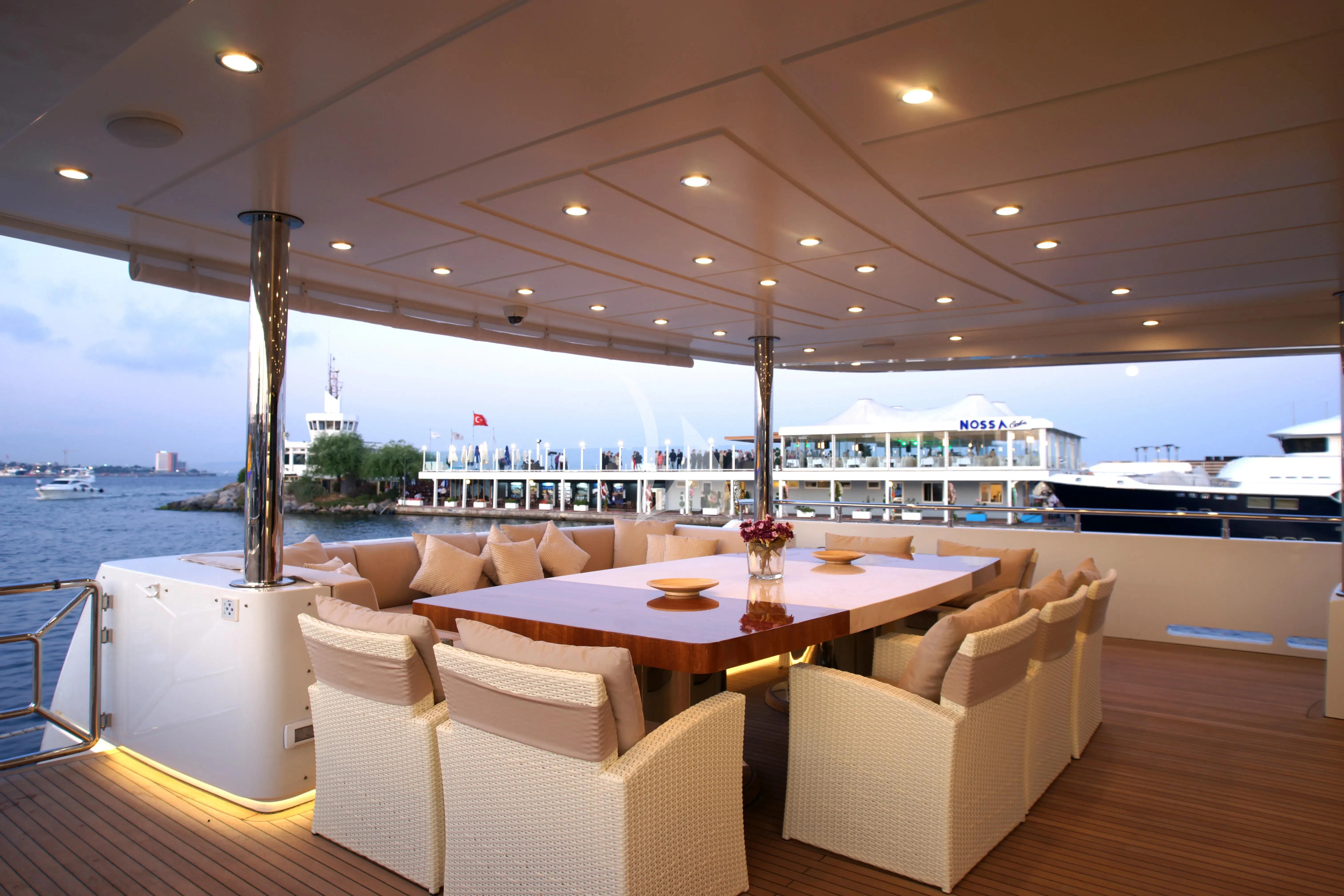 a room with a table chairs and a view of the water aboard TATIANA I Yacht for Sale