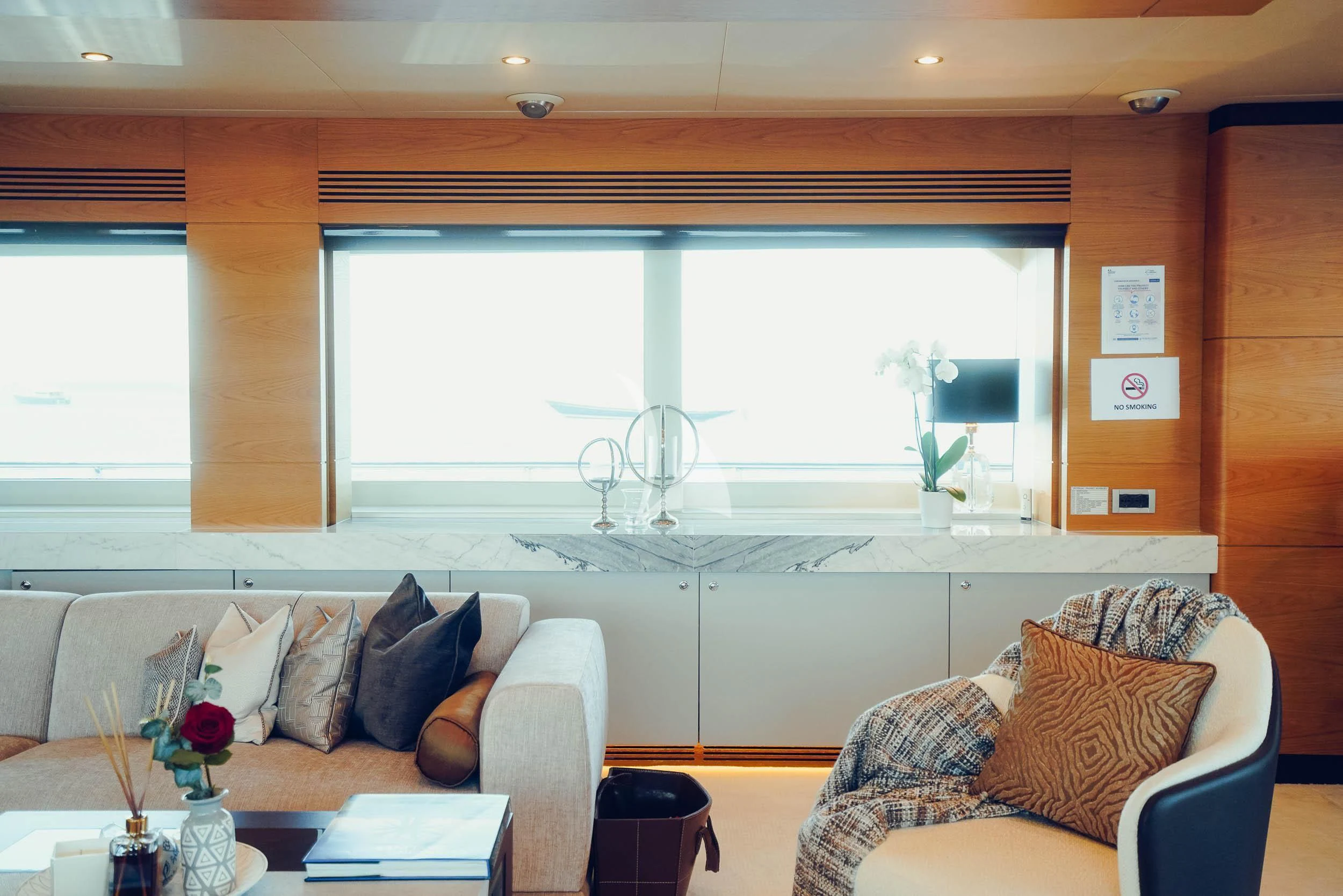 a living room with a couch and a window aboard TATIANA I Yacht for Sale