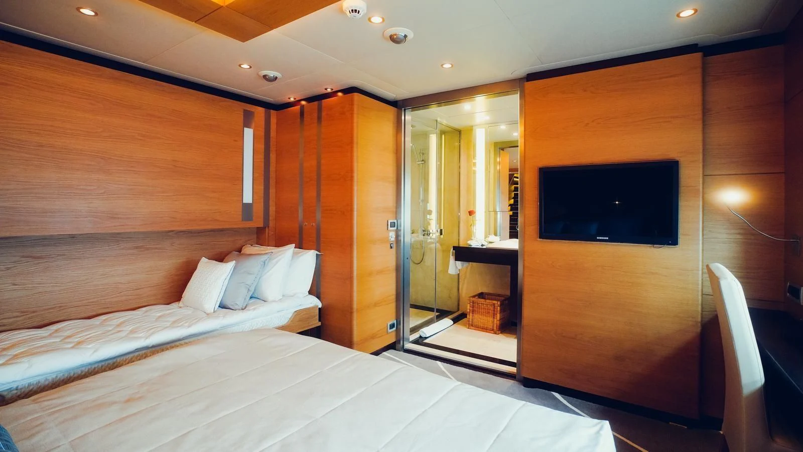 a room with a bed and a television aboard TATIANA I Yacht for Sale