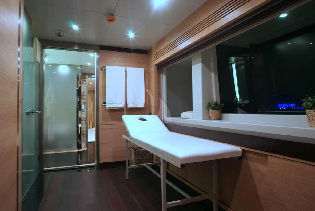 a room with a bench and a table aboard TATIANA I Yacht for Sale