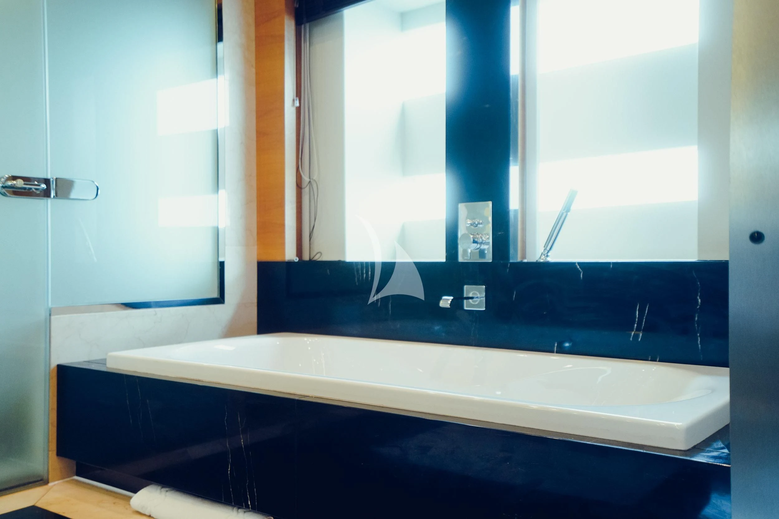 a bathroom with a large mirror aboard TATIANA I Yacht for Sale